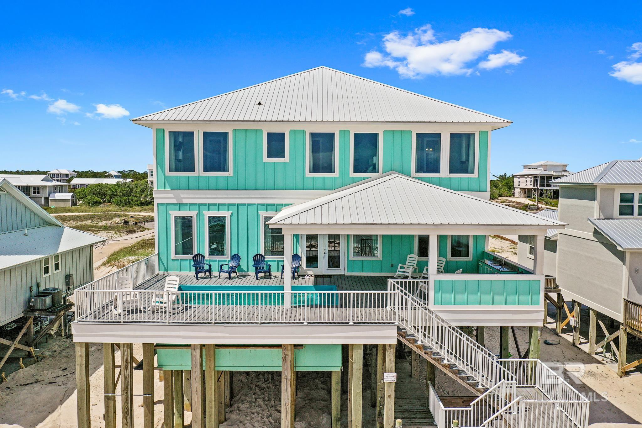 EXTRAORDINARY Gulf Front Beach House with tremendous rental income potential of more than $320k/yr! Gold Fortified construction situated on 70' of pristine beach with an outstanding floorplan, designed for maximum occupancy. This turn-key investment already has $243k on the books for 2023 (includes numerous owner blocks). There are 8 bedrooms (4 are gulf front) and 8 nicely appointed bathrooms with granite counters and upscale tiled showers (& 2 extra 1/2 baths). Huge main living area and fabulous overall amenities including a private heated pool and nice elevator! Wide open, elegant kitchen with Wolf, Kitchen-Aid and Maytag appliances includes 2 refrigerators, 2 dishwashers, double oven, microwave and separate icemaker.  Additional upstairs gathering space and 2 separate laundry areas for added convenience. Plenty of parking underneath and perfect outdoor space for an afternoon shrimp boil. "Let The Good Tides Roll" is a money maker you can be proud to own and enjoy with family and friends. See docs for income info.