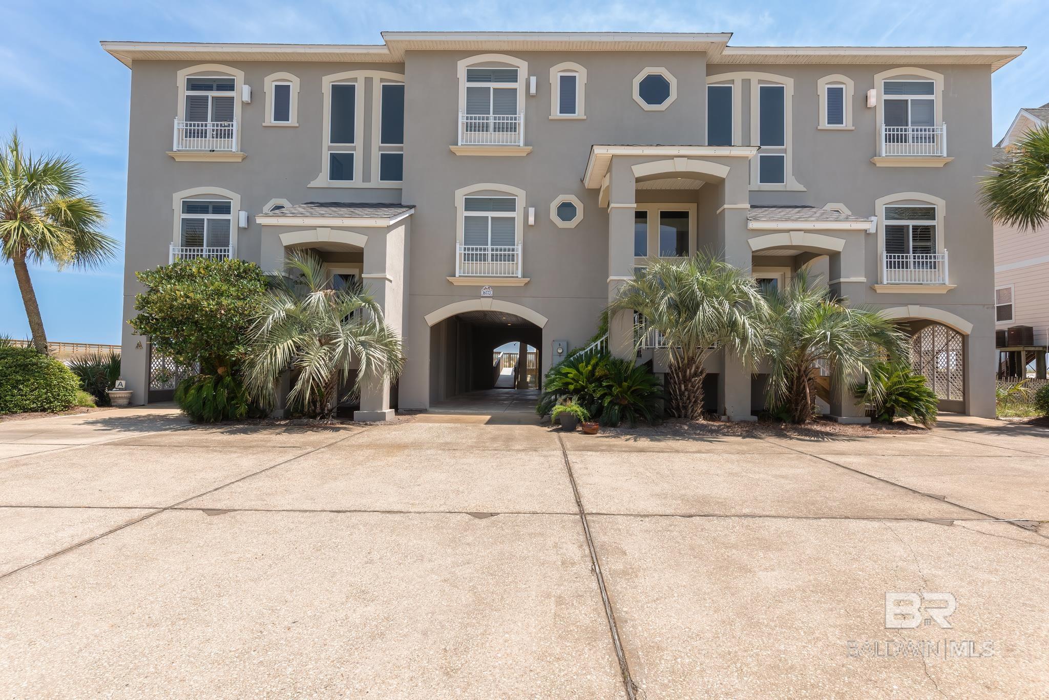 WOW-- Amazing value for a Gulf Front home and truly a little slice of heaven!  This well designed townhome on the east side of a gorgeous tri-plex building features an open kitchen, dining and living area to gaze at the sparkling Gulf of Mexico. The main floor also includes a wet bar, half bath, laundry room and one bedroom with a private bath!  Upstairs you will find 3 more bedrooms, each with its own private bath; 2 with balcony access.  Enjoy beach and gulf views from balconies on both levels! The ground floor has two carport parking spaces, a storage room and boardwalk access. Lovely landscaping and palm trees adorn the front lawn. This building does not allow STRs, making it an ideal primary or secondary home for only 3 very lucky owners, where you can relax and enjoy this fabulous low density Gulf Front location with family and friends. Very low HOA fees.  Seller believes all information to be accurate.  Buyer or buyers agent to verify all information to buyers satisfaction.