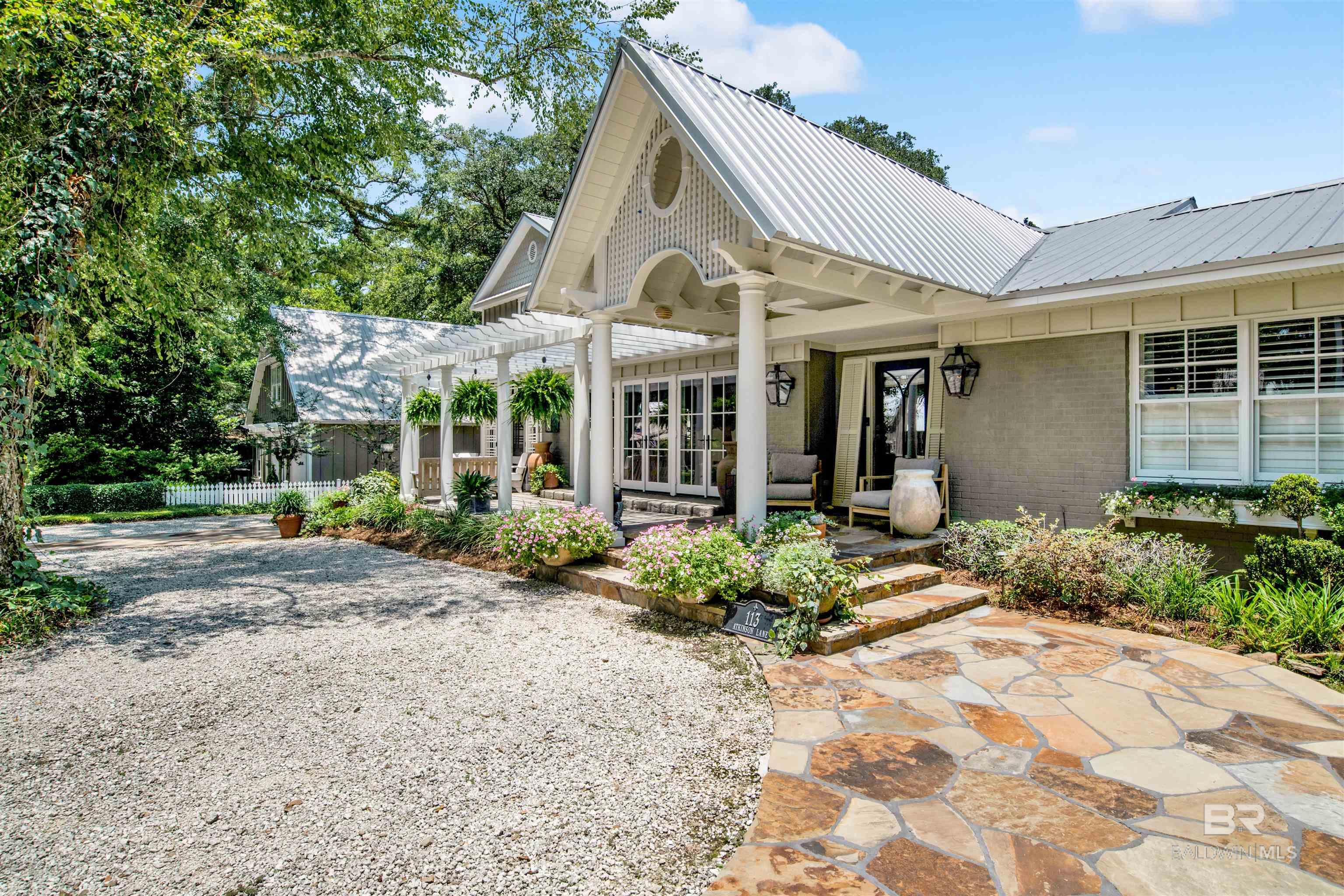 This is an exceptional residence located in The Bluff area of Old Fairhope situated in close proximity to downtown and the bay / Shaded by a canopy of ancient oaks the immaculately maintained grounds with flagstone walkways leading to the herb garden, an arbored front porch with gas light entry and additional access via a screened porch with stone fireplace provides an interesting introduction to the home / Extensive renovations and additions created spacious living areas and numerous amenities / Well appointed kitchen with WOLF appliances including 6 burner gas range + grill, pot filler, large cabinet matched Sub Zero refrigeration, new dual Fisher Paykel drawer dishwashers, 9X5 center island-breakfast bar with icemaker and farm sink / Walk in pantry, fully equipped Butler’s pantry with wine refrigeration-icemaker-dishwasher opens to formal dining room via French doors / Two Main Suites on first level, one with micro jet tub and separate shower, one with large stream shower, both with his and hers closets / Additional room on 2nd level possible study, etc., is currently used as a bedroom without closet space / Additional pantry-office nook adjacent to utility room with folding counter, storage and built in ironing board / Guest suite with full bath above garage identified as 4th bedroom / Spacious double carport with 19X9 heated and cooled workshop / Excellent outdoor entertainment area with heated and cooled ½ bathroom, 21X16 patio covered by a 16x16 UHLMANN commercial strength retractable umbrella, large fireplace and 15X9 cook house with SS commercial sinks, individual hot water heater, Black Stone grill and refrigerator / ADDITONAL FEATURES: 20 KW Honeywell generator system powers the entire home / 2 Rannai tankless hot water systems / Extensive sound distribution / Plantation shutters / NEST Thermostats / RING Doorbell / CAT 5 wiring system / Extensive landscape lighting / Yard irrigation system. / Abundant attic storage.