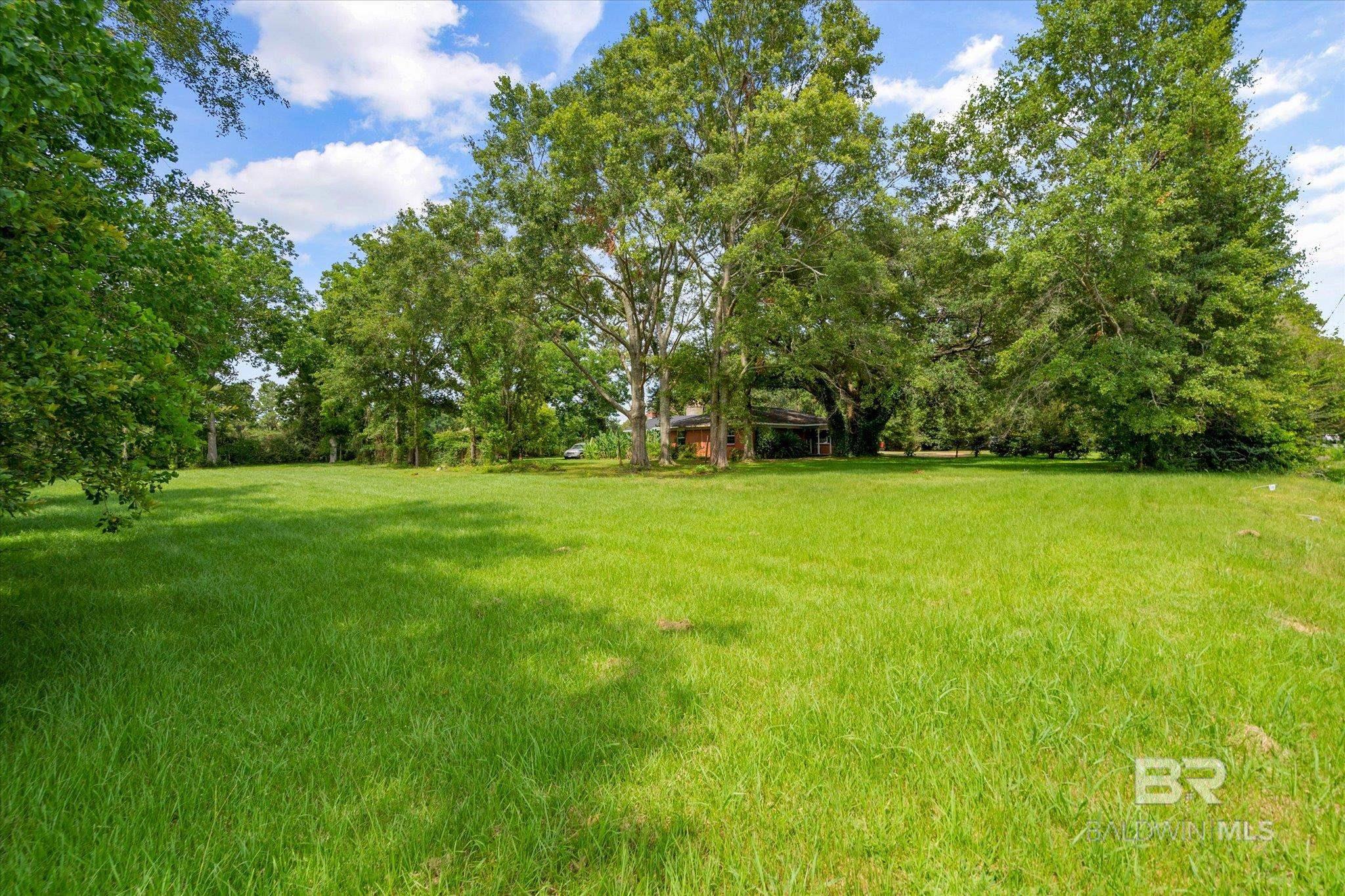 Cleared lot with some mature trees, centrally located in Fairhope! The lot, which was recently subdivided from the house to the east (8631 Morphy Ave, Lot 1), is 100 ft x 236 ft, or approx. 0.54 acres.