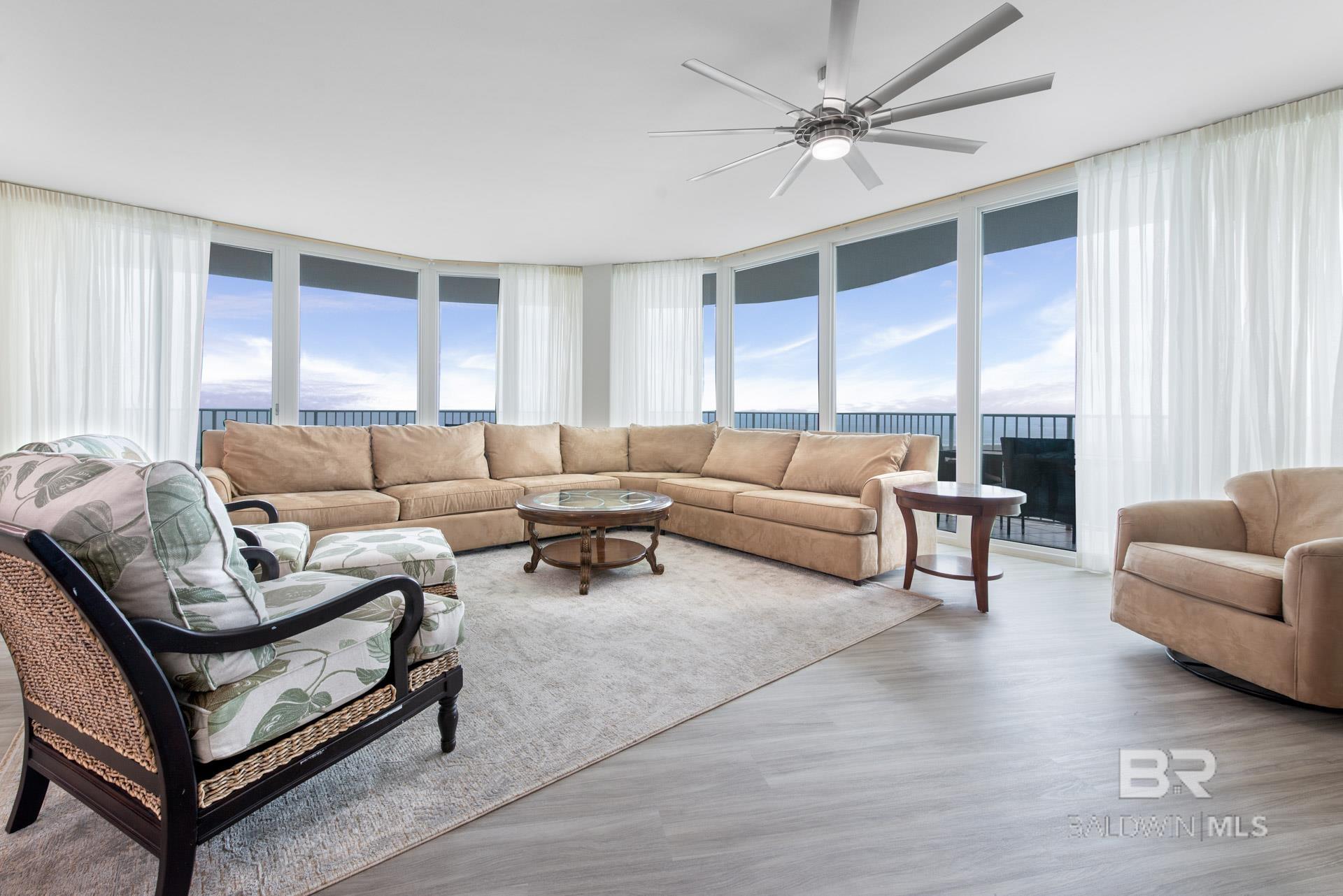 Living room featuring plenty of natural light, light hardwood / wood-style flooring, and floor to ceiling windows