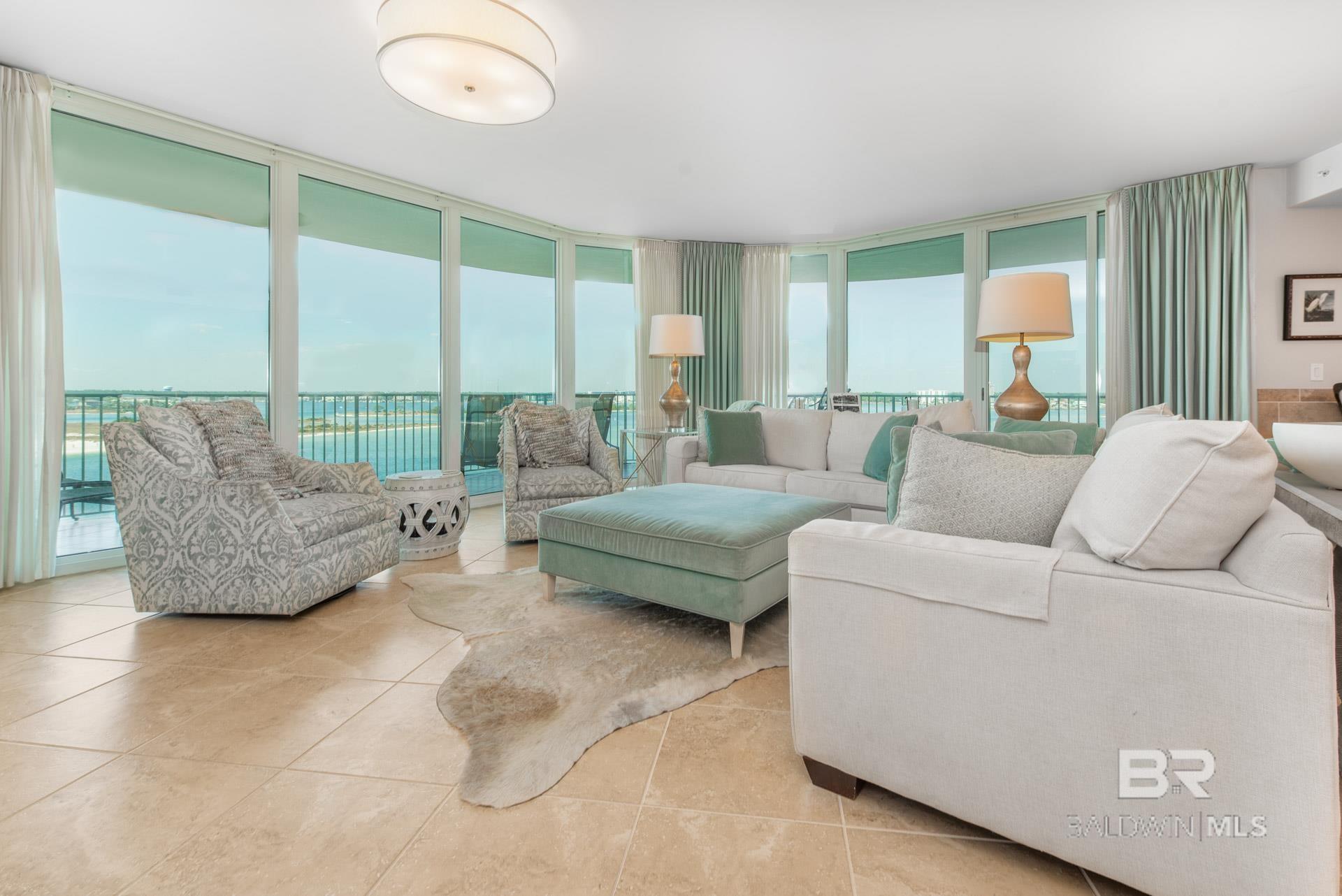 Living room featuring floor to ceiling windows and light tile patterned floors