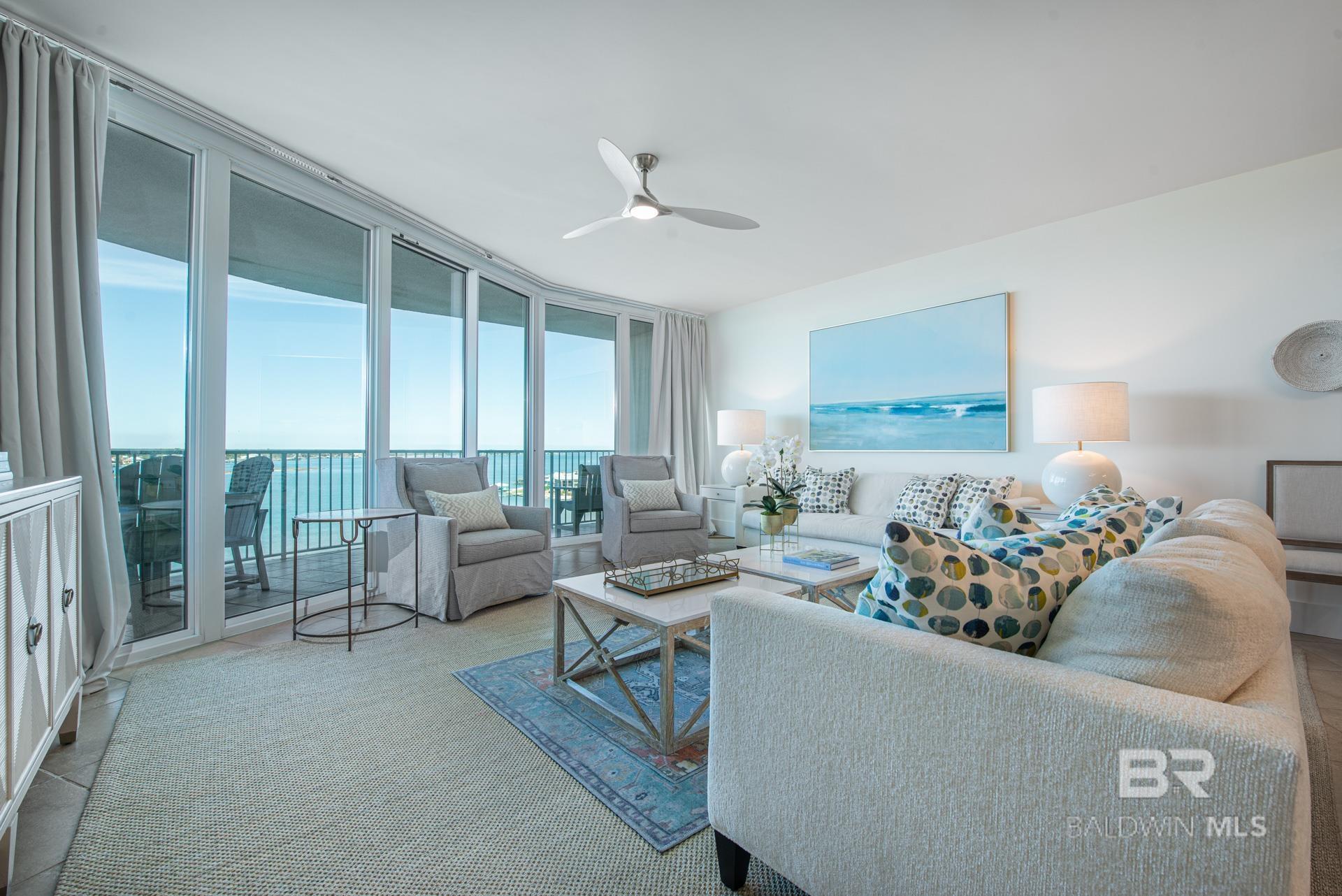 Living room with a wall of windows and ceiling fan