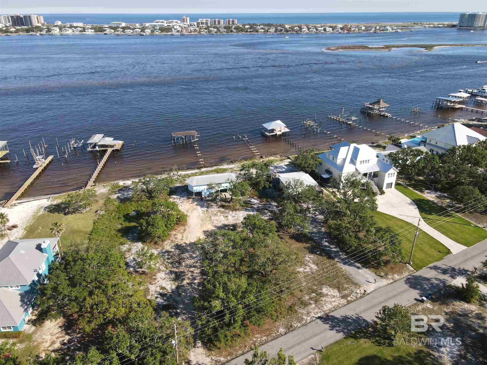 UNIQUE OPPORTUNITY to own TWO WATERFRONT LOTS on Bayou St. John. View The Pass and Gulf from your pier. Imagine your own family compound on these beautiful Bayou front lots with your own private marina and minutes to the Gulf and great fishing. These parcels are being sold together with more than 155 feet on the best waterfront in Orange Beach.  Both lots have older homes on them and are sold "as-is". 28442 Burkart has 2 bedrooms and one bath upstairs and a laundry/bath downstairs. 28470 is usually vacant and features 2 bedrooms and one bath. The lots have 200 feet on the road and are approximately 285 feet deep. Owners have a deeded interest in the boat ramp at the end of Burkart Lane.