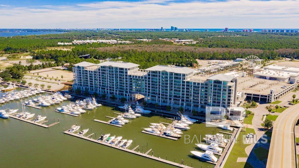 FANTASTIC 3/3 overlooking the Marina & Inter-coastal Waterway.  3rd floor units have expanded covered balconies to give extra large outdoor living space. This unit is located on the east side of the building to give you year round peace and quiet to enjoy the sunsets. Beautiful unit has a huge wall of windows in master bedroom and living space giving you amazing views. Granite countertops, SS appliances, wine chiller, gas range, tiled backsplash, large ceramic tile except bedrooms,  crown molding with a gas grill on the balcony. The Wharf offers many amenities: restaurants, shopping, movie theater, ropes courses and more!! The Oasis which includes a wave pool, lazy river, waterfalls, hammocks, tiki bar with drinks & snacks and an Amphitheater featuring artists of all genres throughout the year. Pet friendly for owners.