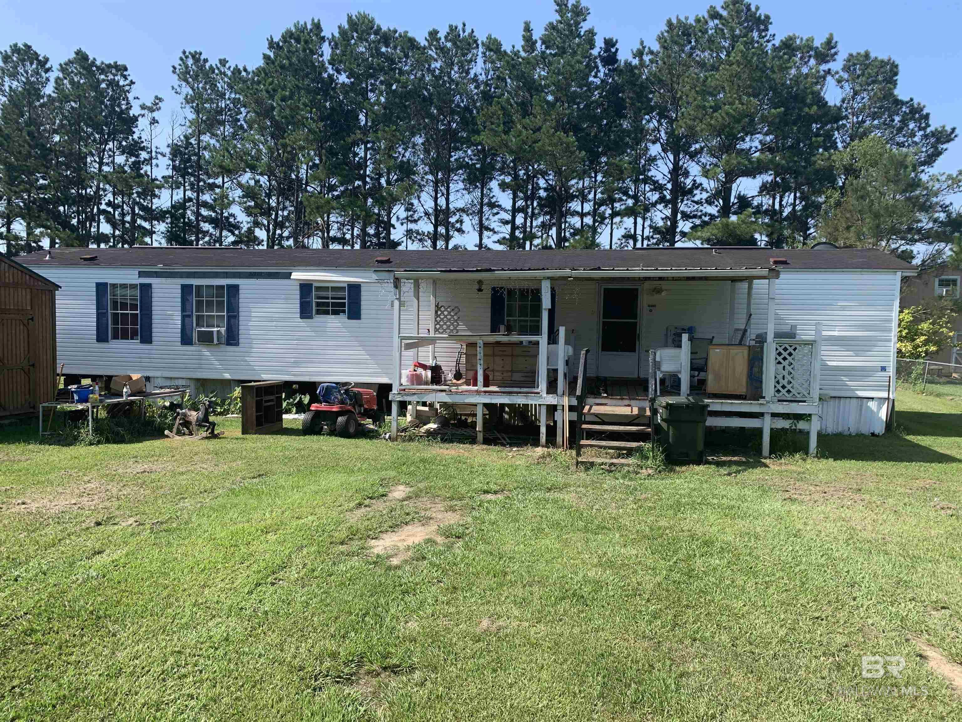 Mobile home sitting on 1/2 an acre minutes from the beach express.  No owner financing.
