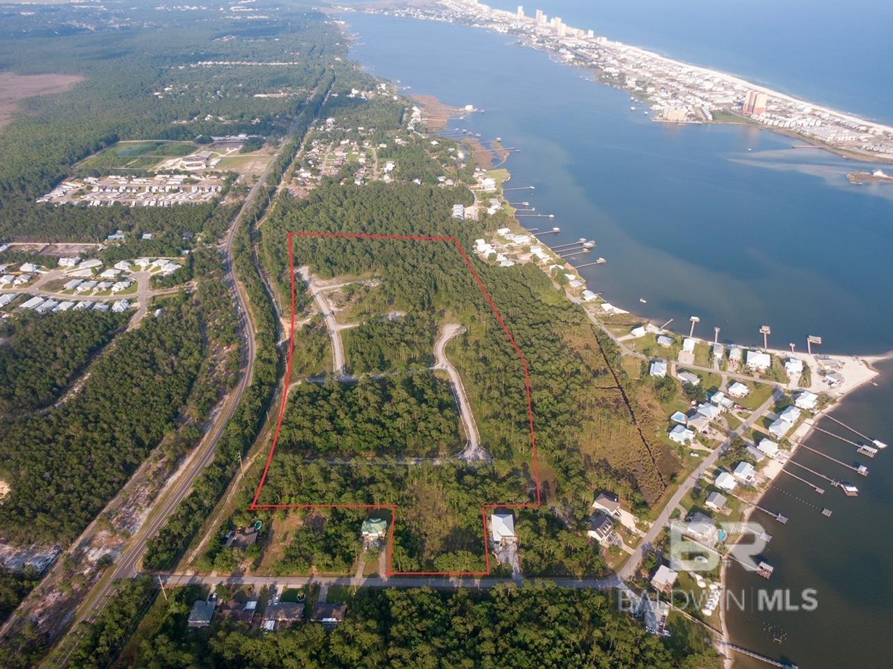 CALLING ALL INVESTORS!  Welcome to your own private oasis! This stunning 40-acre property with about 1800 feet of Fort Morgan Road Frontage is located on Fort Morgan Road, just minutes away from the beautiful Little Lagoon. With its prime location in the highly sought-after Gulf Shores school district, this property is perfect for families looking to build their dream home or for investors looking to develop a new community.   The property features a mix of wooded and cleared areas, providing ample space for a variety of uses. Whether you're looking to build a sprawling estate or develop, this property has endless possibilities.  Don't miss out on the opportunity to own this incredible piece of land. Contact us today to schedule a showing and start planning your future on this beautiful property.  Infrastructure set up, No Active Utilities in place. Zoned R-1-5 All information deemed reliable but not guaranteed, Buyer/Buyer's Agent to verify