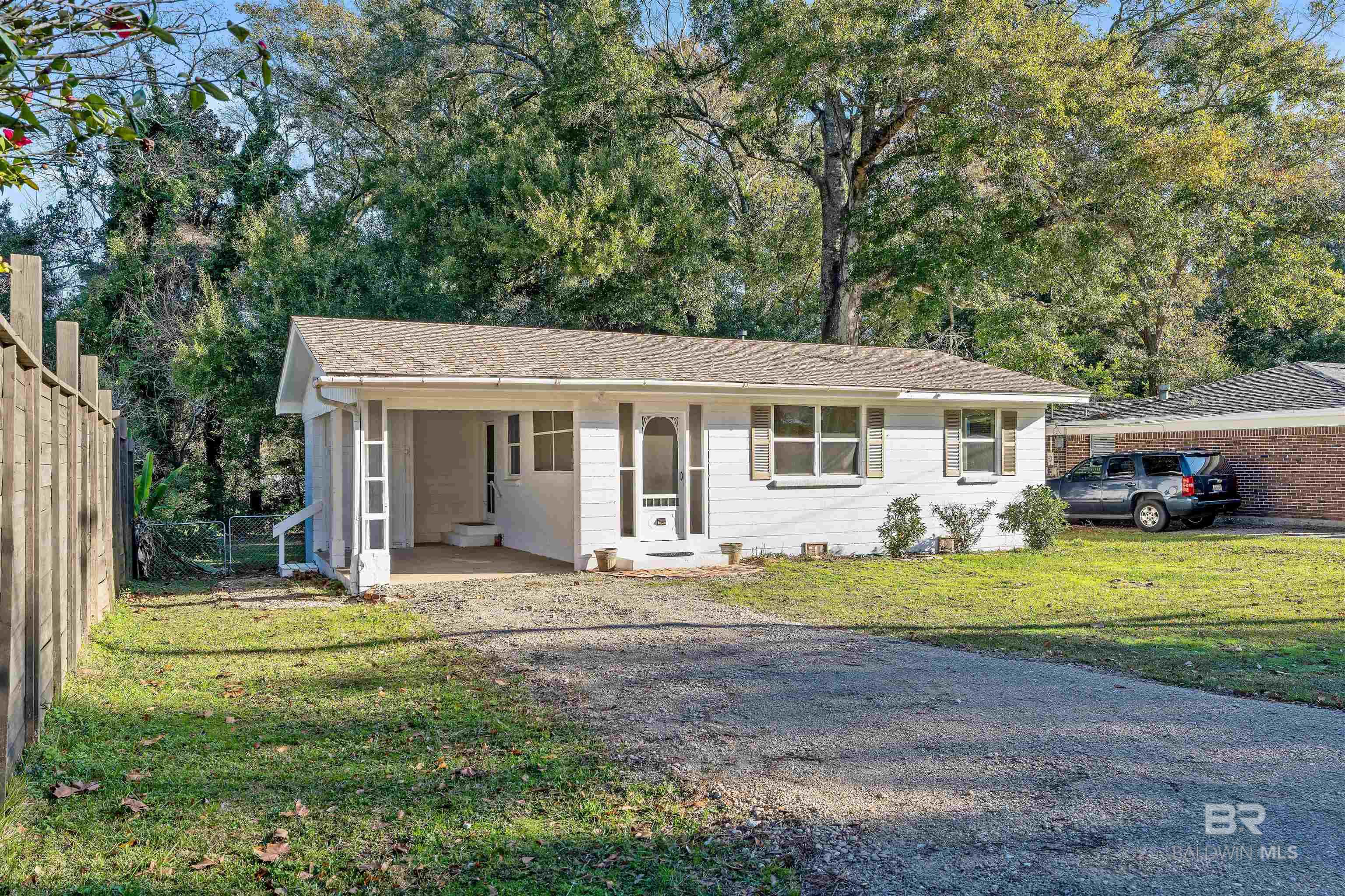 This CHARMING FAIRHOPE COTTAGE just 2 minutes from the center of downtown has been remodeled with new kitchen cabinets, quartz countertops, new microwave and dishwasher, flooring, interior paint, lighting, and electrical.  Home features 2BR/1BA with an attached single carport on a large lot with a huge, fenced backyard.  This is a great investment property, or for first time buyers or second home buyers to enjoy all the Eastern Shore has to offer. All Information provided is deemed reliable but not guaranteed. Buyer or buyer’s agent to verify all information.