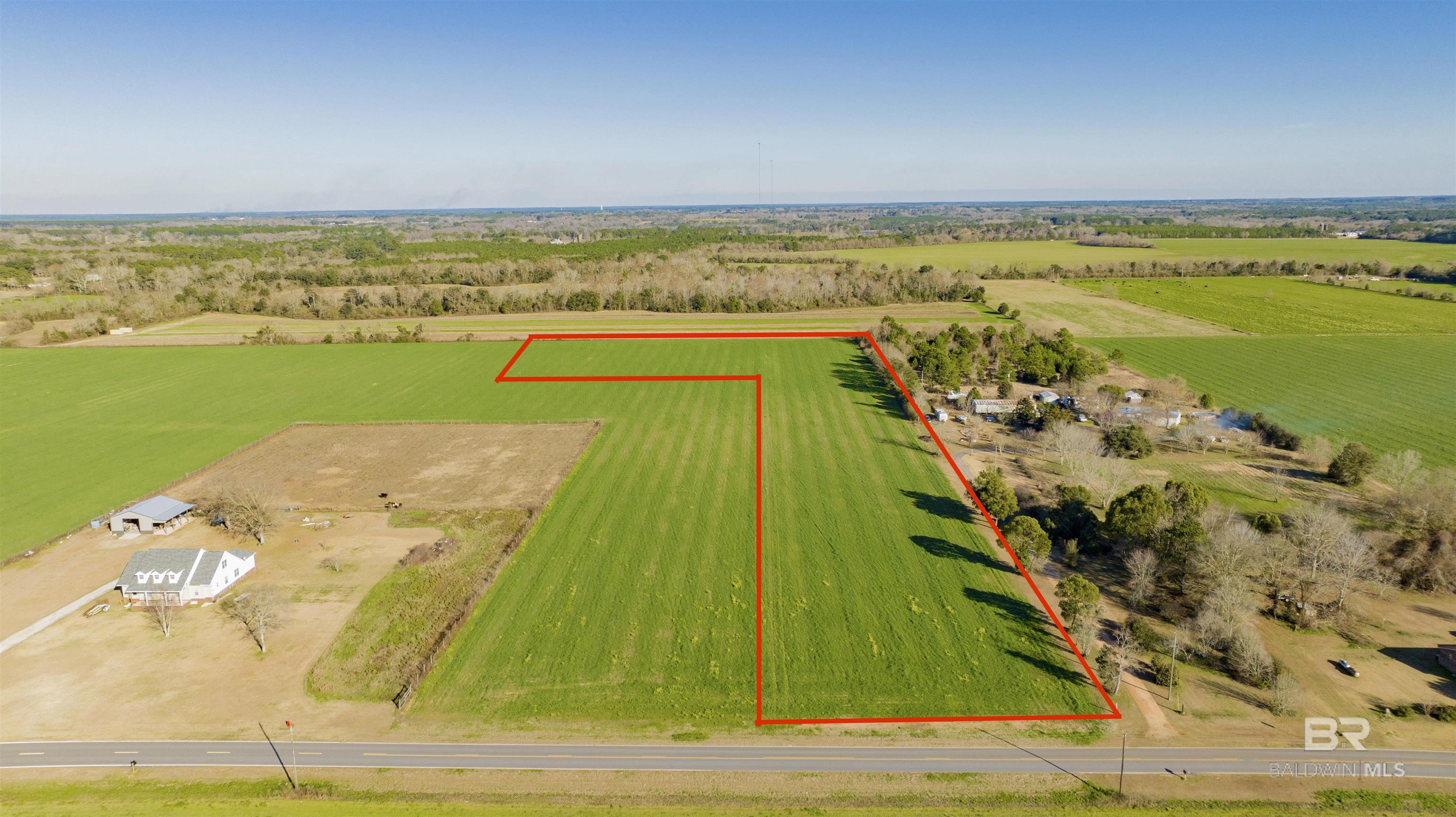 7.5 Acres of beautiful land located in Loxley. Currently farmed, but ready to be transformed into an excellent spacious homesite. 2200 square foot minimum home is required per deed restriction.