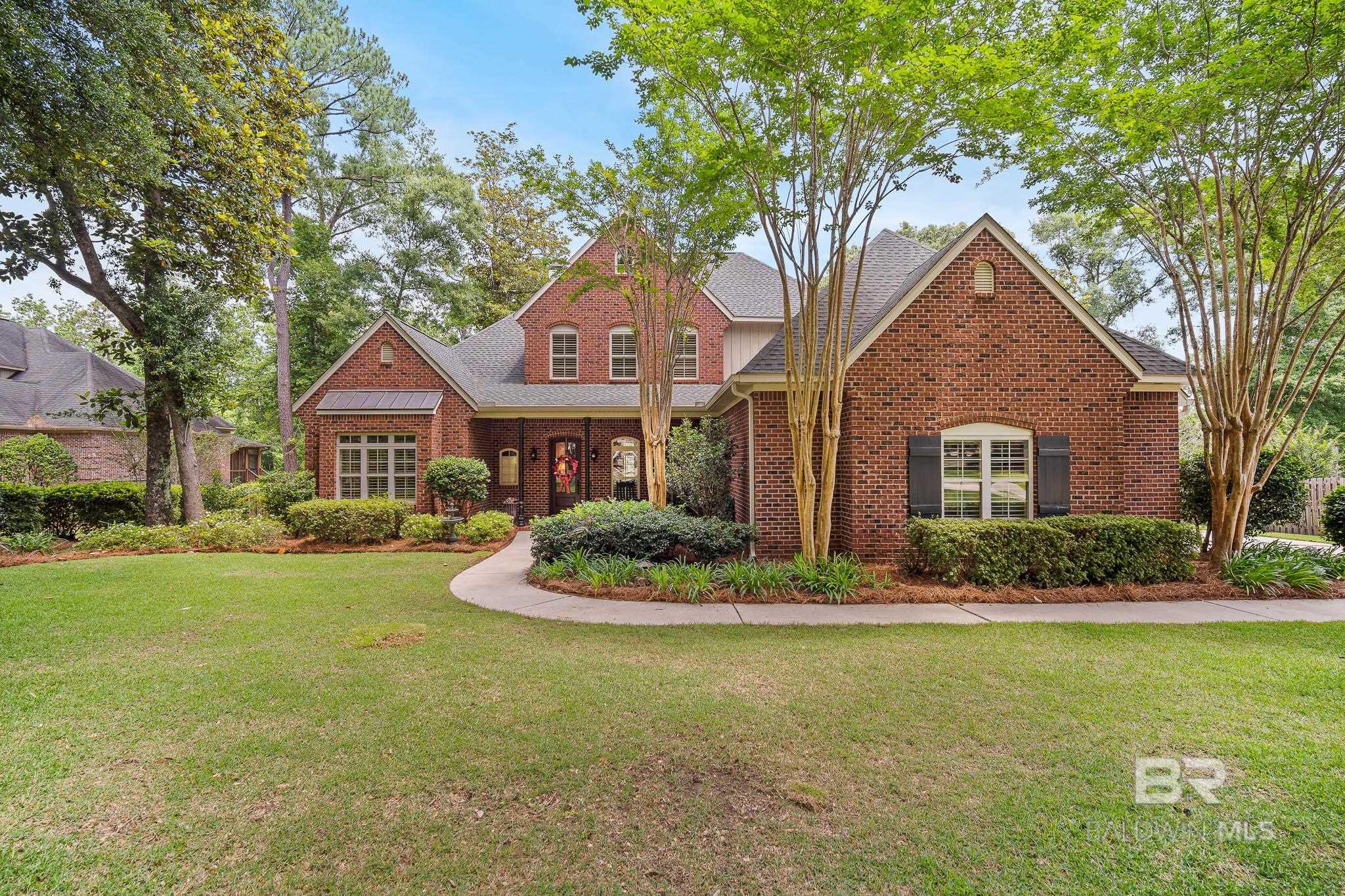 Beautiful, custom brick home sits perfectly on just over an acre lot in the Woodlands at Malbis. From the moment you step inside, you will love the soaring ceiling and abundance of natural light in the spacious living room, complete with hardwood floors, wood burning fireplace with a lovely wood mantle and custom bookcase with storage. The kitchen is spacious and boasts plenty of storage, granite countertops, a center island with seating, a gas range and stainless appliances including double ovens and a wine cooler. You can relax by the fireplace in the gathering room located just off the kitchen or enjoy the view of the pool in the heated & cooled sunroom. The very spacious primary bedroom has a vaulted ceiling and an en-suite with separate vanities, jetted tub and HUGE walk-in closet. There is an office/study on the main level that could also be a 5th bedroom. Upstairs you will find three additional bedrooms, one with a vaulted ceiling and one with an en-suite. Enjoy the covered patio with Trex decking that is perfect for entertaining. The best part of the backyard has to be taking a splash in your own private pool! The professionally landscaped lot goes beyond the fence in the back and also has security lighting. Home has a new Bronze certified roof in April 2022, new HVAC upstairs in 2021 and downstairs in 2019. If you are looking for space, convenience, a well-built home with a pool, all in a great subdivision close to public and private schools, you don’t want to miss this one!