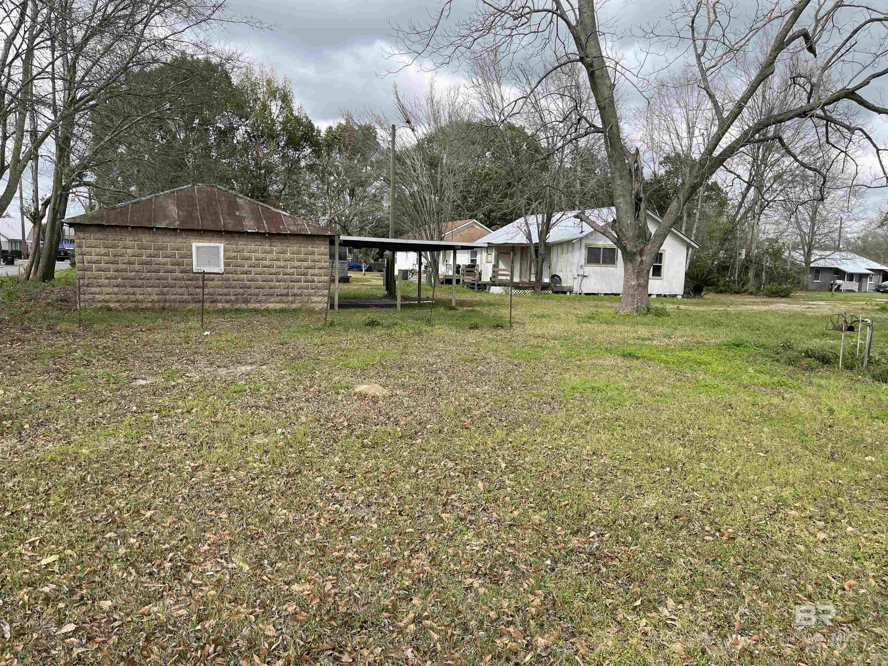 Here is an opportunity to own three lots in downtown Loxley and visible from State Highway 59. Great location for an office building, retail space or so many other  uses. There is an old house on one of the lots and a detached garage on another one and the third is unimproved. Property being sold "as is".