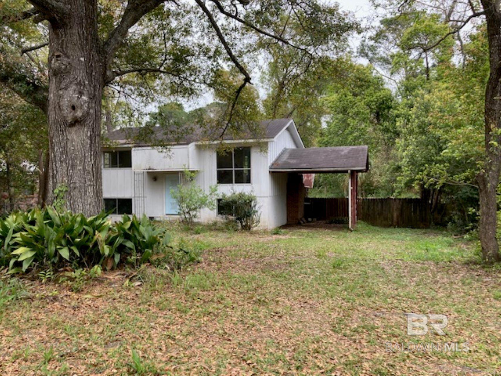 This is a real Fairhope fixer upper or rebuild on this great deep lot within walking distance to downtown.  The beautiful oak tree in the front yard adds charm and character to the property. Rear access to property is available.  There are two rooms plus a den downstairs.  If this property aligns with your vision and budget, this could be an exciting opportunity to create your dream home or investment property in Fairhope. Sold as is.