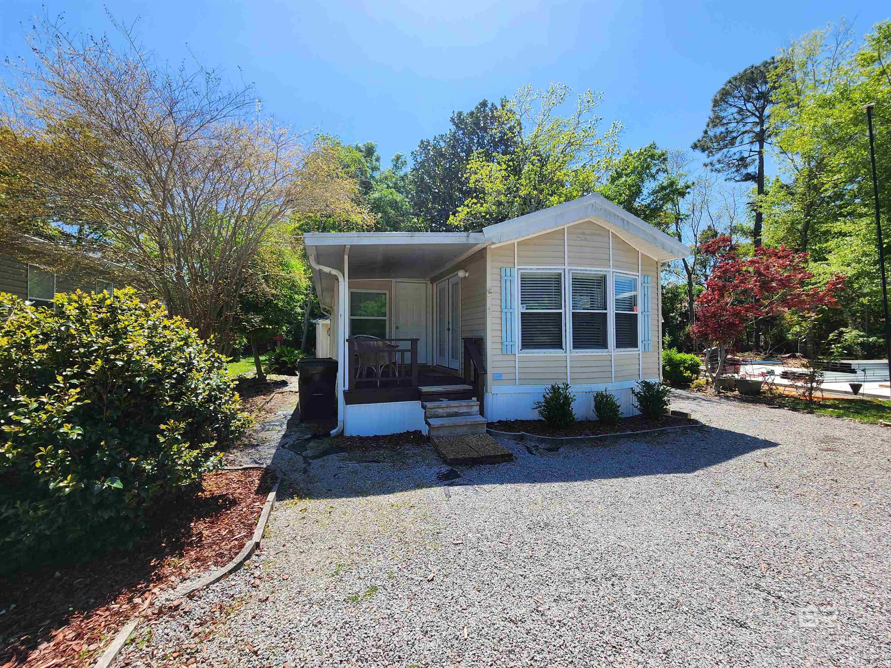 This charming 2 bedroom, 1 bathroom park model is in the sought after Spanish Cove Community located in Lillian, AL. The lot size is 40' x 82.1 feet. The Park model had an addition added that includes the 2nd bedroom and a bonus living/rec room. The addition also has a back door and a front door access. The main living area and the bonus room both have access to the covered front porch. There is an 8x14 outbuilding that houses extra storage and the washer and dryer hookups. The Spanish Cove Community has so much to offer. There is 24 hour security, an outdoor pool (That is covered and heated in the winter months for year-round use.), a beautiful pier that looks over Perdido Bay, barbaque area, private beach area, a club house, basketball courts, tennis courts, shuffle board, fitness center, laundry, etc. Check out this property and the Spanish Cove Community. Lillian Alabama is rural, but in close proximity to Alabama and Florida's white sand beaches. There is a public boat lauch just down the road for all you boating needs. Call me or your favorite realtor today to schedule a showing. Buyer and Buyers agents are responsible for any verification information/inspections/square footage, etc that is pertinant to the sale of the property. All information is believed to be true and accurate as stated in the listing. The property will be sold "AS-IS, WHERE-IS".