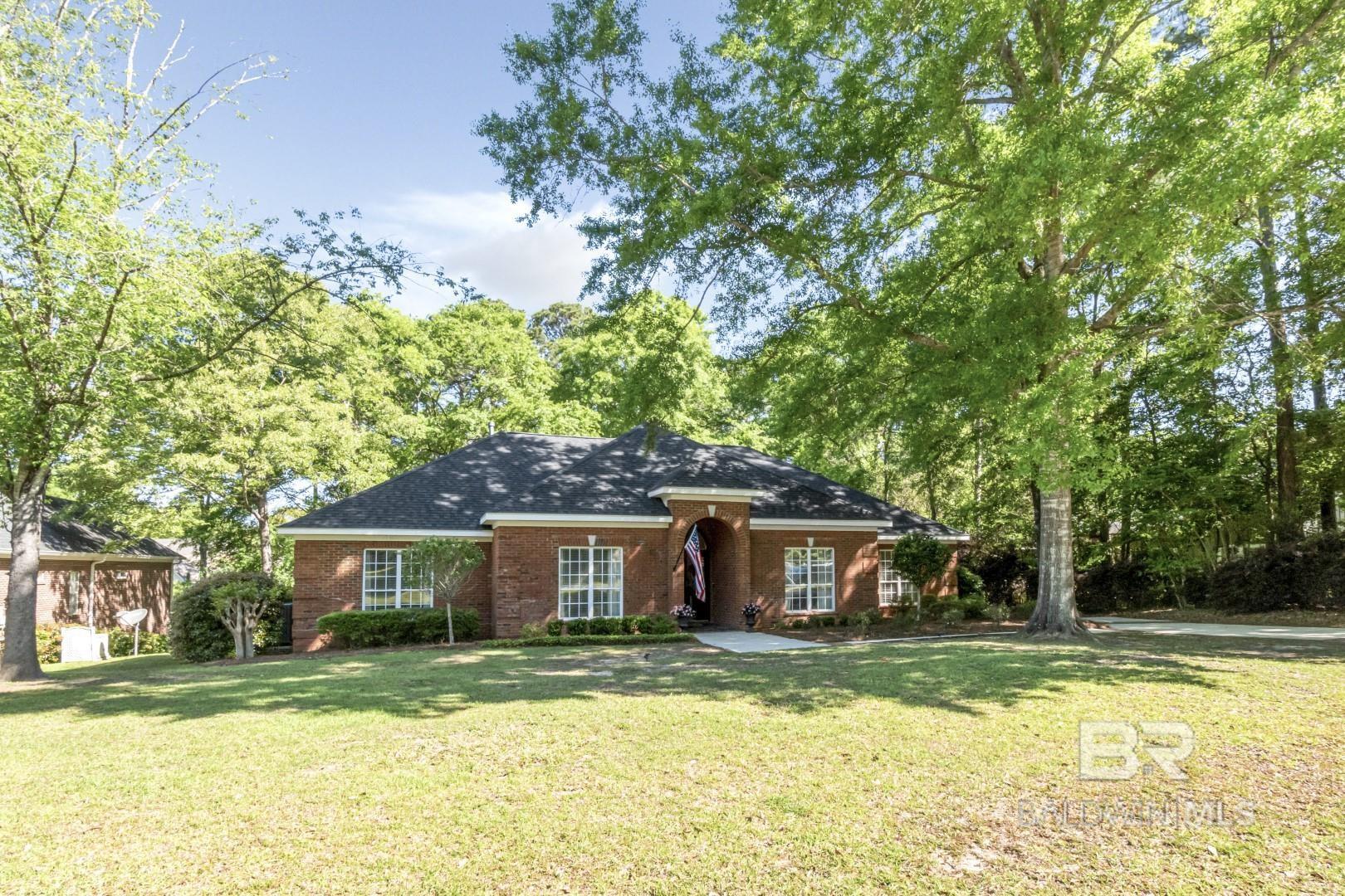 WELCOME HOME to 8737 Ash Ct located on a quiet cul de sac in Timber Creek! This all brick family home with over 3100 sq boasts 4 BR, 3.5 B, bonus and side entry double garage with workshop space. The lovely covered entrance leads into a foyer flanked by French doors to a living/office/play/flex room and dining room; The expansive, sunny great room features wood flooring, a fire place, large windows that open to the covered back porch and deck overlooking a private backyard. Off the great room is the spacious kitchen with ceramic tile, granite counters, cabinets galore, and eating bar; the kitchen opens to the breakfast area, powder room, door to laundry room with sink and stairs up to the bonus room. The split floor plan features a guest room, guest bath plus the primary bedroom with wood flooring, custom built-ins and ensuite bath with spa tub, shower, large vanity with double sinks and 2 walk in closets! The opposite guest/children’s wing features 2 bedrooms with new wood flooring and a large shared bath. If indoor and outdoor entertaining spaces is what you need in your next home…..look no further! Termite bond with Arrow. BONUSES: FORTIFIED ROOF (2021); HVAC (2023); TimberCreek amenities include two pools, tennis courts (pickle ball), and a clubhouse, all conveniently located near I-10, shopping, and within the highly sought after Spanish Fort School District. Don't miss out on this opportunity. This home will exceed your expectations! Schedule your showing today!
