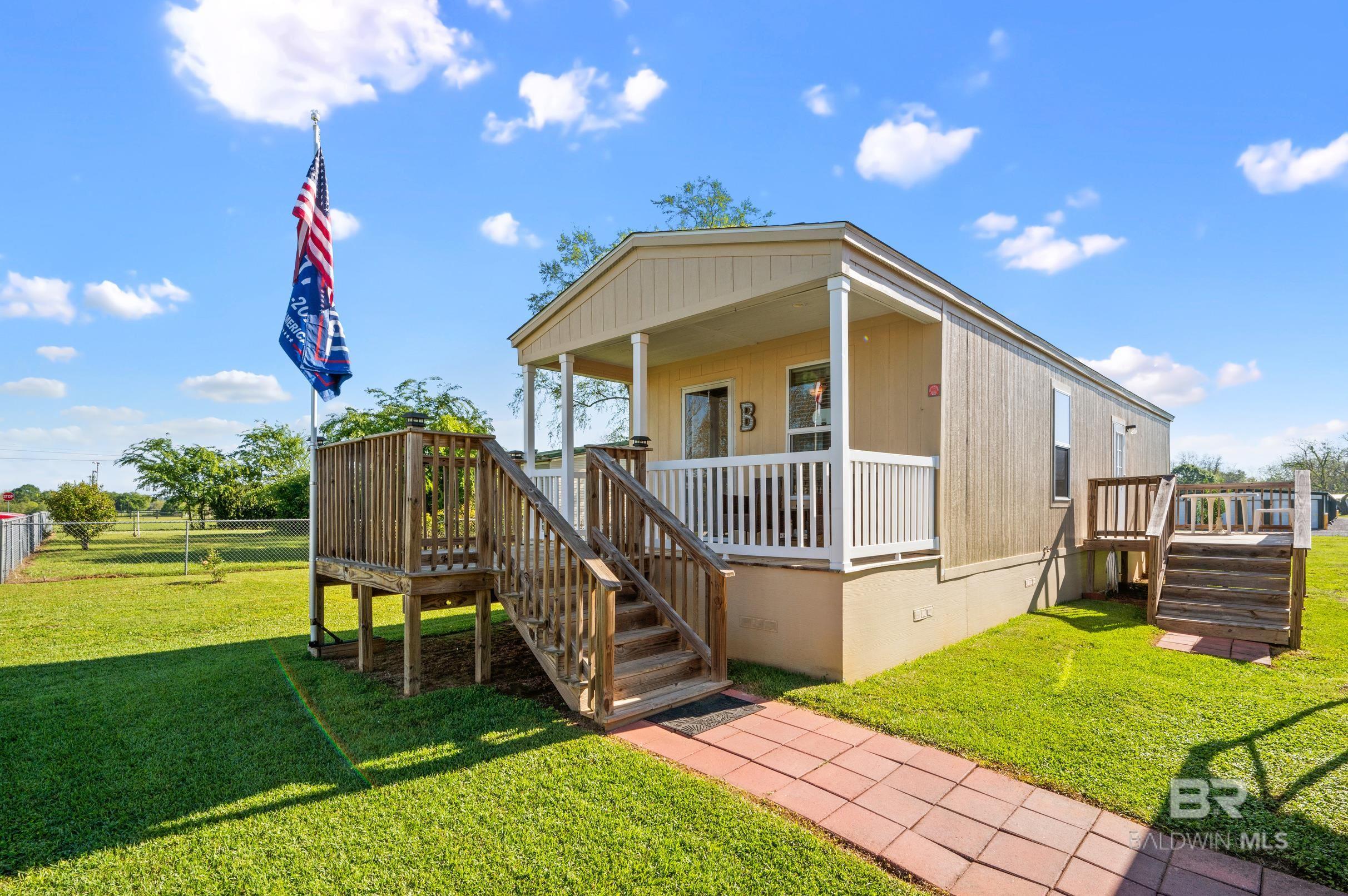 OPEN HOUSE: April 27, 2024 Time: 11am to 4pm!!! This Beauty is soo immaculate!! Turn Key!! Just bring your luggage and furniture!! Pulling up to it you'll notice the well maintained yard. It's a 2 Bedroom 1 Bath 16x50 mobile home with Hardie board siding and hardie board skirting!! Sits on .37 acres of land.  NO HOA!! Has 22x26 metal carport! 16x16 front porch deck, and it's extended by 8x8! The back deck is 8x16 large enough to have cookouts and more!!  Has 2 sheds on the back an 8x16 Barn style storage Shed and a 6x6 Shed!! Potential RV Set up on the lot. Minutes away from Point Clear!!