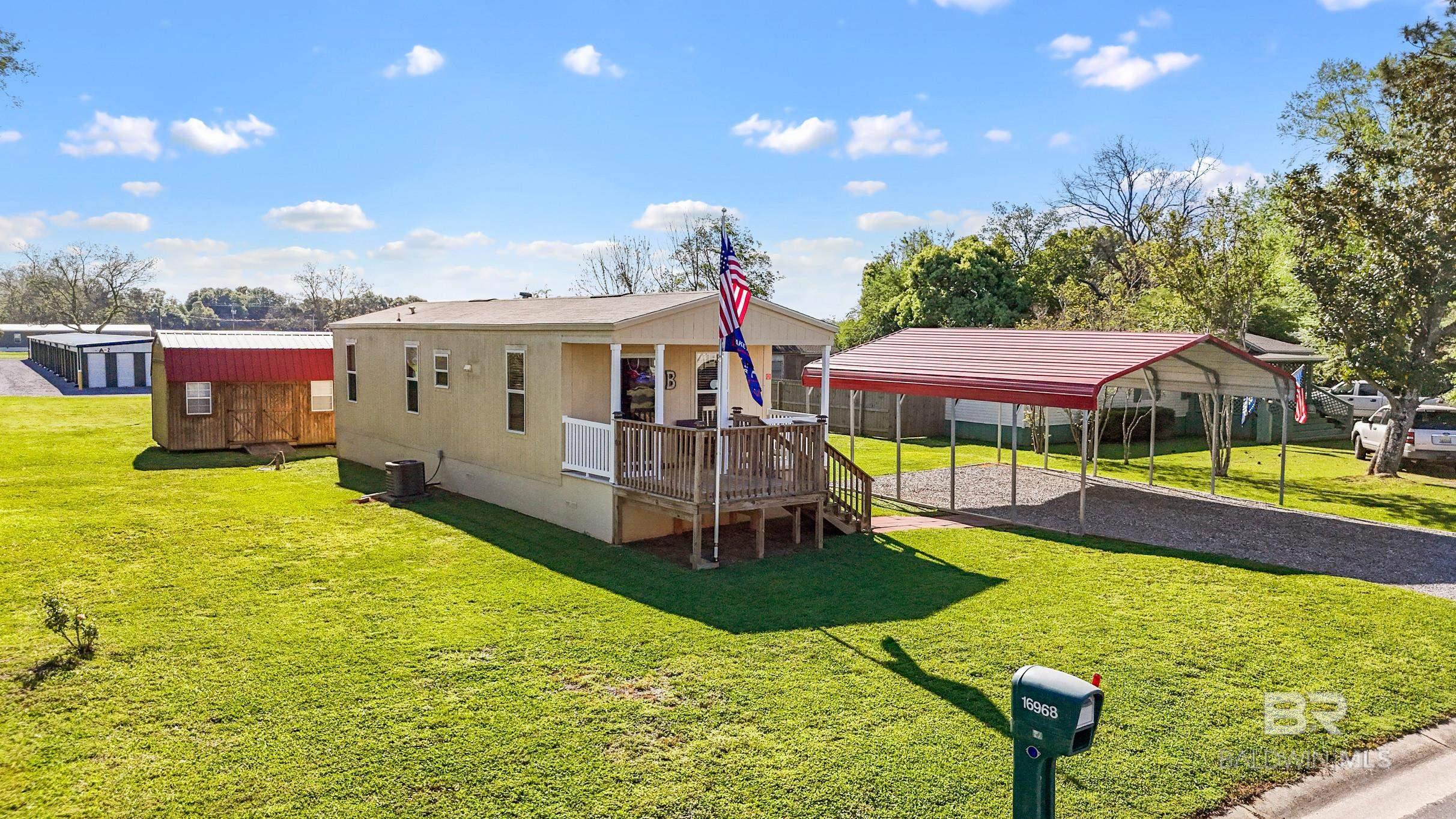This Beauty is soo immaculate!! Turn Key!! Pulling up to it you'll notice the well maintained yard. It's a 2 Bedroom 1 Bath 16x50 mobile home with Hardie board exterior and hardie board skirting!! Sits on .37 acres of land. NO HOA!! Has 22x26 metal carport! 16x16 front porch deck, and it's extended by 8x8! The back deck is 8x16 large enough to have cookouts and more!! Has 2 sheds on the back an 8x16 Barn style storage Shed and a 6x6 Shed!! Potential RV Set up on the lot. Minutes away from Point Clear!! Buyer to verify all information during due diligence.