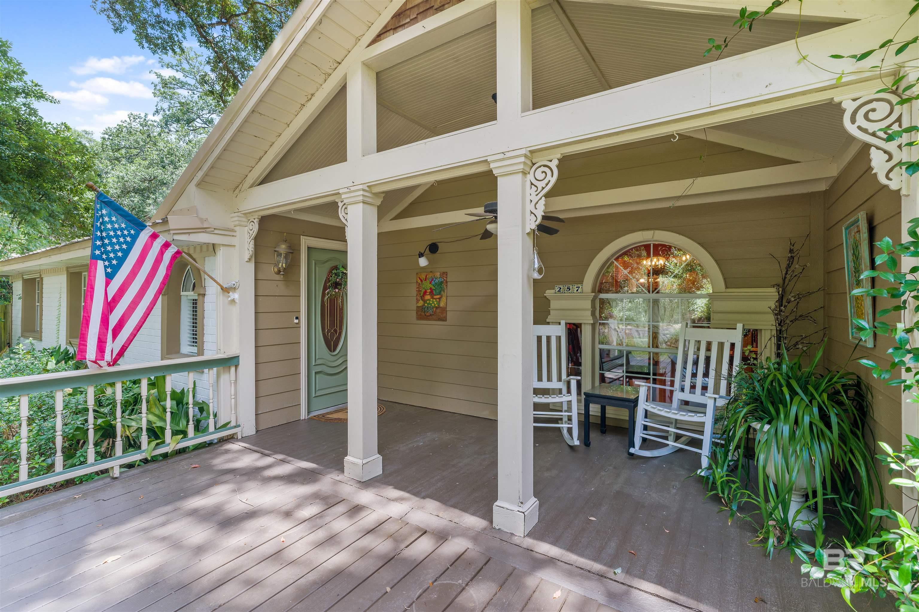***NEW PRICE - LET'S MAKE DEAL!*** Step into a masterpiece at 257 Morphy Avenue, a haven in Fairhope's Fruit and Nut District where historic elegance meets contemporary artistry. This 4-bedroom, 3.5-bathroom sanctuary spans 3,315 square feet, offering a canvas for those who cherish both space and style. As you cross the threshold, original wood floors narrate a story of timeless beauty, guiding you through a space adorned with stainless steel appliances and sleek butcher block countertops in the kitchen. The living room's arched entryways and vaulted ceiling create a sense of expansive creativity, while custom trim work throughout the home lends an air of refined craftsmanship. An attached mother-in-law suite provides a private gallery space for your guests, ensuring both comfort and seclusion. Imagine entertaining in the intimate courtyard, with home-crafted cocktails from the wet bar setting the scene for unforgettable evenings. The property is surrounded by mature oak trees, their graceful branches framing your artistic retreat with the essence of southern Alabama charm. One of the home's standout features is the exposed wall in the guest bedroom, a historical mosaic of construction materials sourced from Clay City Tile, a company with deep roots in Fairhope's architectural heritage. The living room's historic fireplace, a mesmerizing centerpiece built in 1850 and imported from Belgium, adds a touch of Old World allure to the space. Just one block from Church St and two blocks from Section St, this residence is a gateway to downtown Fairhope's vibrant cultural tapestry, including the Arts and Crafts Festival, Mardi Gras parades, and the Lighting of the Trees. A leisurely half-mile stroll brings you to the Fairhope Municipal Pier, where the coastal scenery becomes a serene backdrop for your artistic inspiration. Seize the opportunity to own this enchanting Fairhope retreat, where every corner whispers tales of history and the warmth of southern hospitality. Buyer