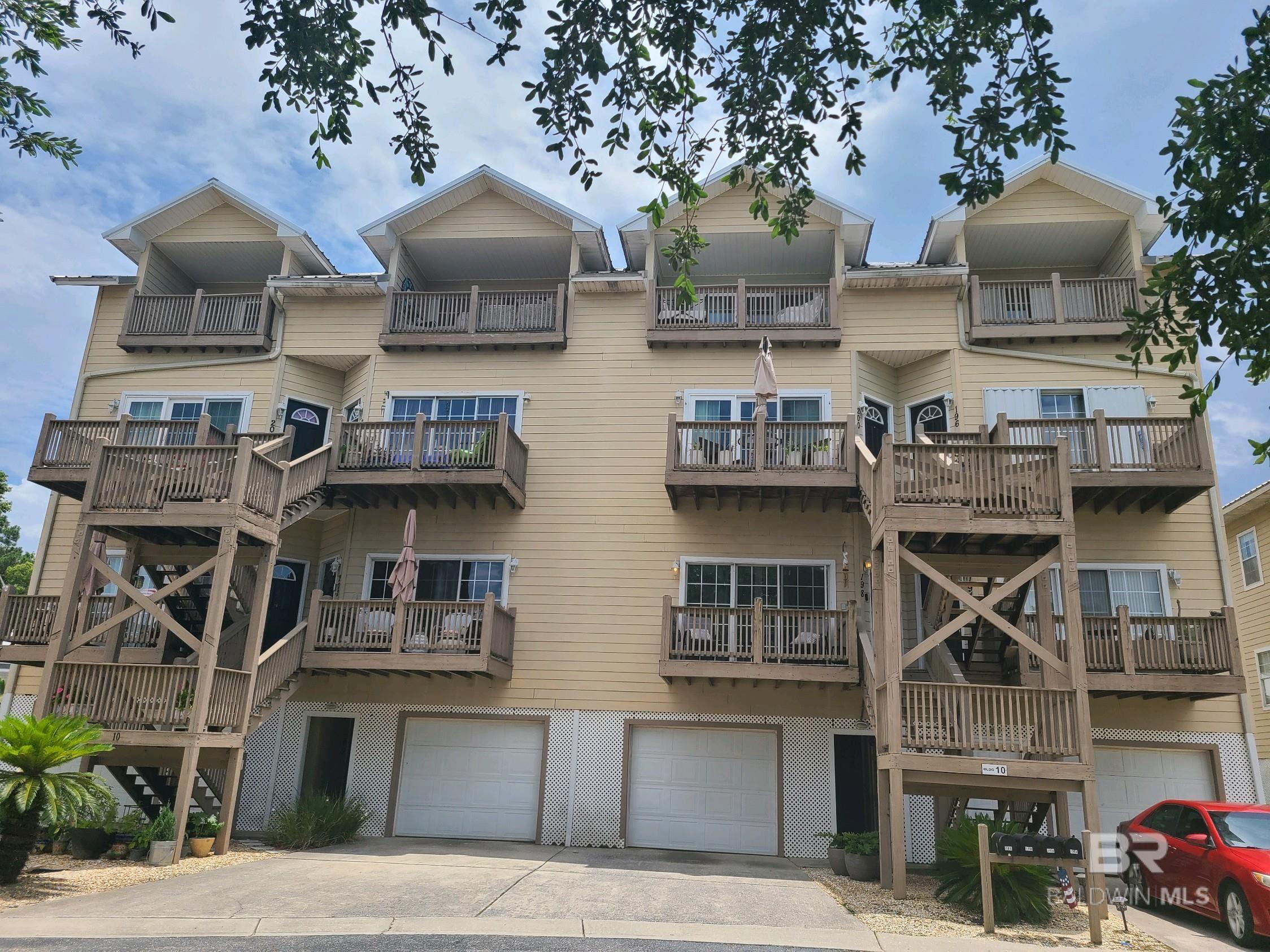 ***VRM: seller will entertain offers between $269,000 and $279,000***Discover the epitome of coastal luxury on the Eastern Shore in this two-story condo nestled in the serene Sunset Bay Villas of Daphne. With panoramic views of the bay and the iconic Bayway, this home is a haven of tranquility and beauty. The current owner is a designer and it shows! The one word needed for this condo is FABULOUS! As you ascend in the elevator that is located right off of your spacious one car garage, you enter an expansive living room with 10-foot ceilings, elegant bamboo flooring, and exquisite crown molding. The living room’s hurricane proof sliding glass doors opens to a balcony offering mesmerizing views of Mobile Bay, the community pool, and a peaceful pond. The kitchen is a culinary delight, boasting white cabinets, solid surface countertops, new stainless steel KitchenAid appliances, a wine rack, a breakfast bar, and tiled floors. Adjacent to the kitchen, the dining area features a handsome dry bar with beautiful cabinets as well as a pantry under the stairs. The main floor also houses two generously-sized bedrooms, while the upstairs is dedicated to the primary suite, a luxurious retreat, featuring a tray ceiling, bamboo floors, and TWO walk-in closets. The laundry room is also located upstairs and is complete with cabinets, a sink, a clothes hanging area and access to the walk-in attic that has plenty of room for storage. Step through the hurricane proof sliding glass doors out onto the covered balcony and bask in the breathtaking views, particularly during the sunrise and sunset. You will not want to leave this tranquil spot! The en-suite primary bathroom is a sanctuary, complete with a make-up vanity, dual vanities, a large soaking tub, a separate shower, and a fabulous walk-in closet. Condo amenities are: pool, hot tub, tennis courts, a stocked fishing pond, a BBQ pavilion, and a private pier to Mobile Bay! Buyer to verify all information during due diligence.