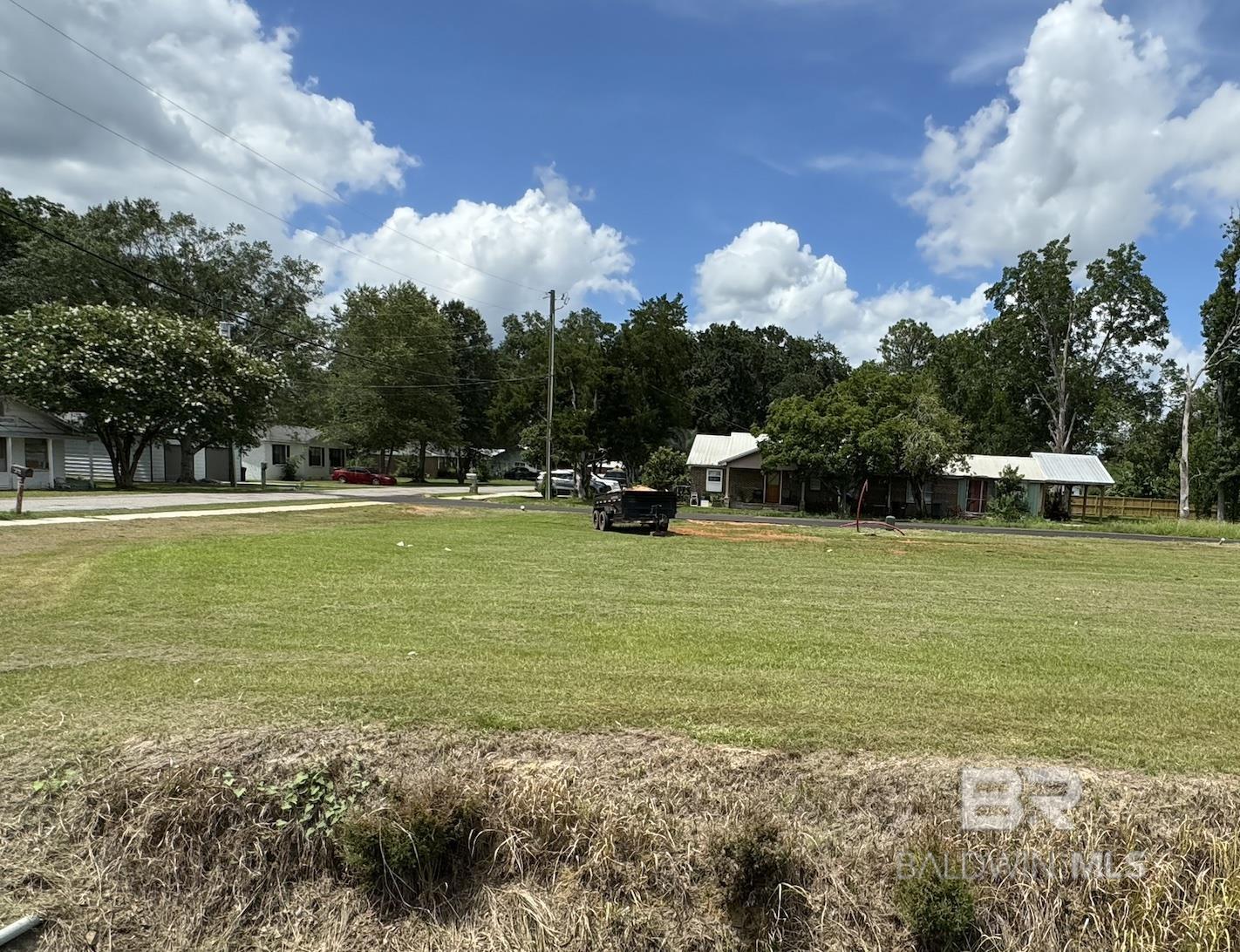 Affordable corner lot which is flat and ready to build on in a great location in Loxley! 58' roadside x 138' deep. Setbacks are 10' sides and 30' front and back. City water, sewer, trash, gas. Access to home from right of way behind home and water/sewer/power available.  No POA. (buyer/buyer's agent to verify setbacks and & utilities) City water, sewer, trash, gas. No POA. Listing agent is a licensed REALTOR in the state of Alabama and is a member of the selling entity. Buyer to verify all information during due diligence.