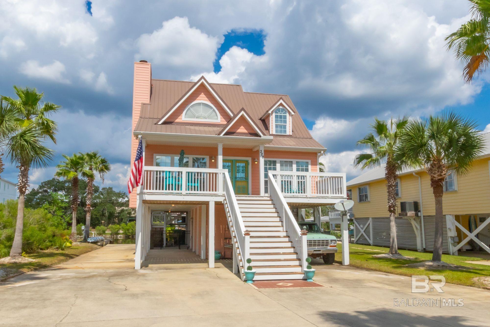 Gorgeous, 4 bedroom, 3 bathroom house located in the heart of Gulf Shores! Enjoy beautiful sunsets with views of the Little Lagoon! This property has a private boat launch, jet ski lift, covered sitting area by the water, beautiful landscaping, and so much more. The inside of the house features an open-floor plan with tile/hardwood flooring, stainless steel kitchen appliances, granite counters, etc. This house won't last long! Buyer to verify all information during due diligence.