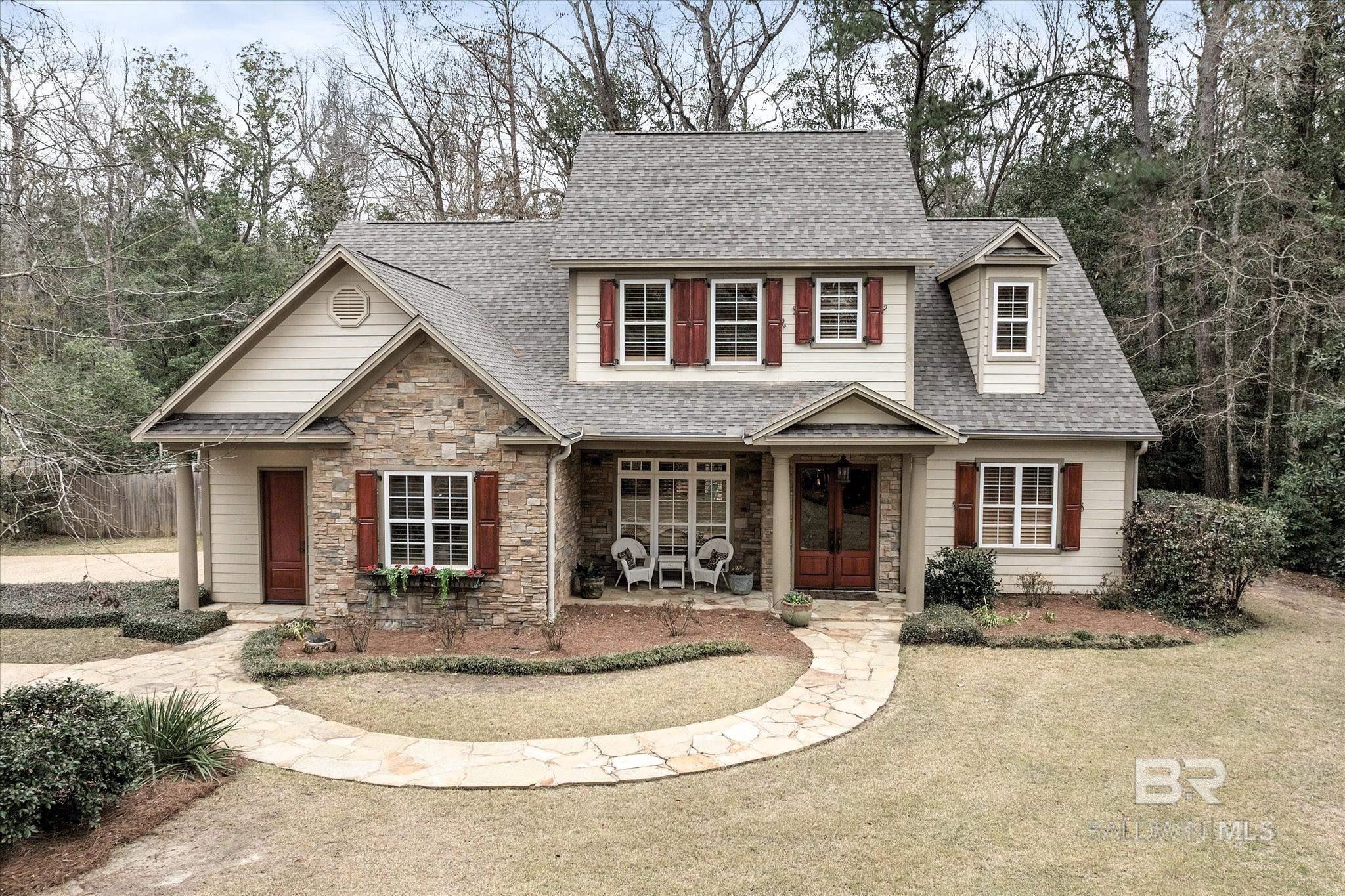 Step into the charm and elegance of this stunning French Provincial home, nestled in the heart of Montrose Village in the picturesque Fairhope area. With deeded bay access, this home offers the perfect combination of luxury, comfort, and convenience. As you enter, soaring ceilings greet you and a welcoming family room complete with a cozy fireplace—perfect for gatherings and relaxation. The open-concept design flows seamlessly into the dining area, offering a beautiful view of your private, lush backyard. The chef-inspired kitchen is a masterpiece, featuring gorgeous wood cabinets, stone countertops, a gas cooktop, and a breakfast bar. The cozy breakfast nook is ideal to start your day.  The expansive primary bedroom, conveniently located on the main level, offers a peaceful retreat with a sitting area and direct access to the back patio, where you can unwind and enjoy the delightful, landscaped yard. The walk-in closet provides ample space for all your wardrobe needs, and the spa-like primary bath features elegant tile floors and a walk-in shower. Upstairs, a charming balcony overlooks the family room, offering a unique touch of style and providing access to three spacious bedrooms, each with its own private bathroom. SELLER IS OFFERING A $10,000 BUYER INCENTIVE WITH AN ACCEPTABLE OFFER. Buyer to verify all information during due diligence.