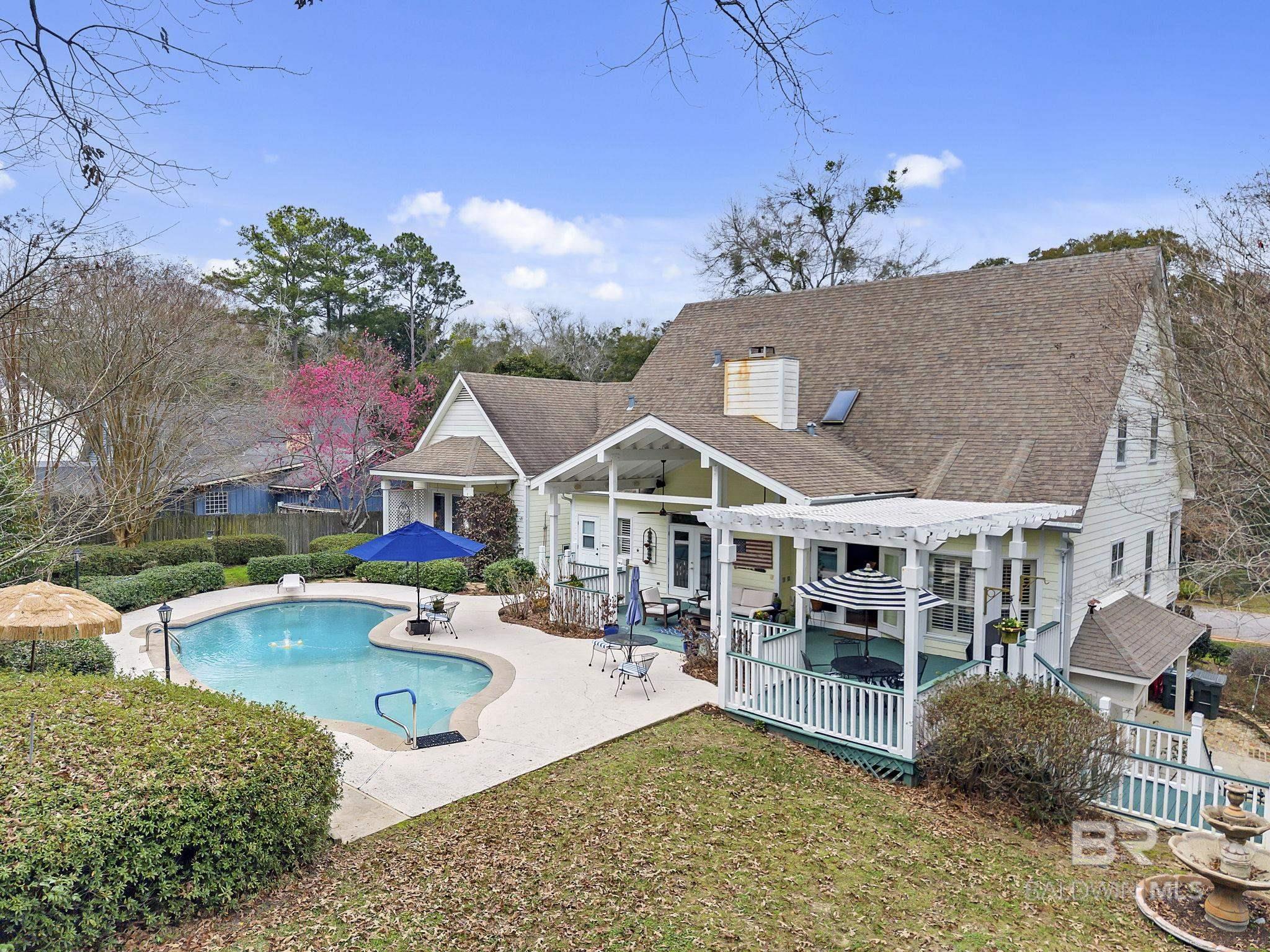 This stunning 5-bedroom, 4 full-bath, and 3 half-bath home seamlessly blends style, comfort, and convenience. Located within walking distance to both the town and the bay, this home offers modern living with easy access to amenities and nature.Key Features: Spacious Master Suite: Enjoy a cozy fireplace and a private ensuite bath. Chef’s Kitchen: A massive island perfect for cooking and entertaining. Two Fireplaces: One in the living room and one in the master bedroom for added warmth. Outdoor Retreat: Relax on the covered patio by the sparkling pool, with a convenient half bath nearby. Basement Workshop: Ideal for projects, with an additional half bath.Upgrades Include: Master bedroom patio, pool, and deck resurfaced, new plantation shutters, 3 new AC units, new double ovens, refrigerator, microwave & cubby, new wine cooler, remodeled master bedroom and much more!Don’t miss your chance to own this exceptional home and experience luxurious coastal living at its finest!  Buyer to verify all information during due diligence.