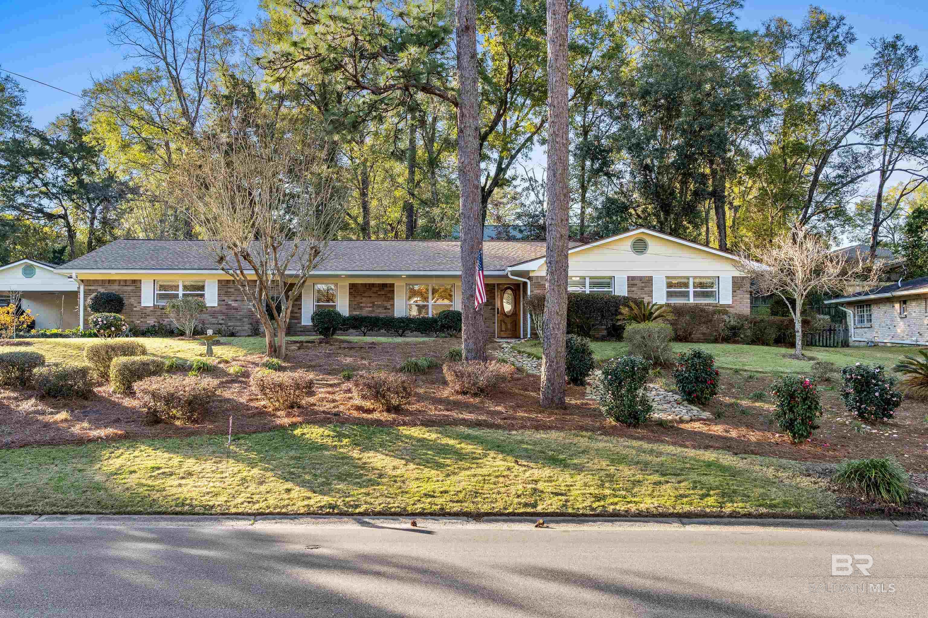 Charming, Fully Renovated Fairhope Home Near Fairhope West Elementary!This stunning 3-bedroom, 2-bath home was completely renovated in 2019 by Swain Byrd Design, offering a perfect blend of modern updates and timeless charm. Ideally located just minutes from downtown Fairhope and Fairhope West Elementary, this home provides both convenience and a sought-after lifestyle.The gourmet kitchen is a showstopper, featuring quartz countertops, an island with black walnut countertops, and an electric cooktop—perfect for cooking and entertaining. Additional highlights include CoreTec flooring, smooth ceilings, a tankless hot water heater, a central vacuum system, and custom louvered shutters.Major updates include a fortified roof (2022), new HVAC (2021), seamless gutters, and gas heat. The property has been fully rewired and re-plumbed, ensuring modern efficiency. The spacious primary suite boasts a huge walk-in closet, and the home also includes a two-car attached carport. Perched on a high lot, this home offers beautiful views of the neighborhood while. maintaining a sense of privacy. The backyard is a serene retreat, perfect for relaxing or entertaining in a peaceful setting. This home is a rare find in one of Fairhope’s most desirable locations. Schedule your showing Today! Buyer to verify all information during due diligence.