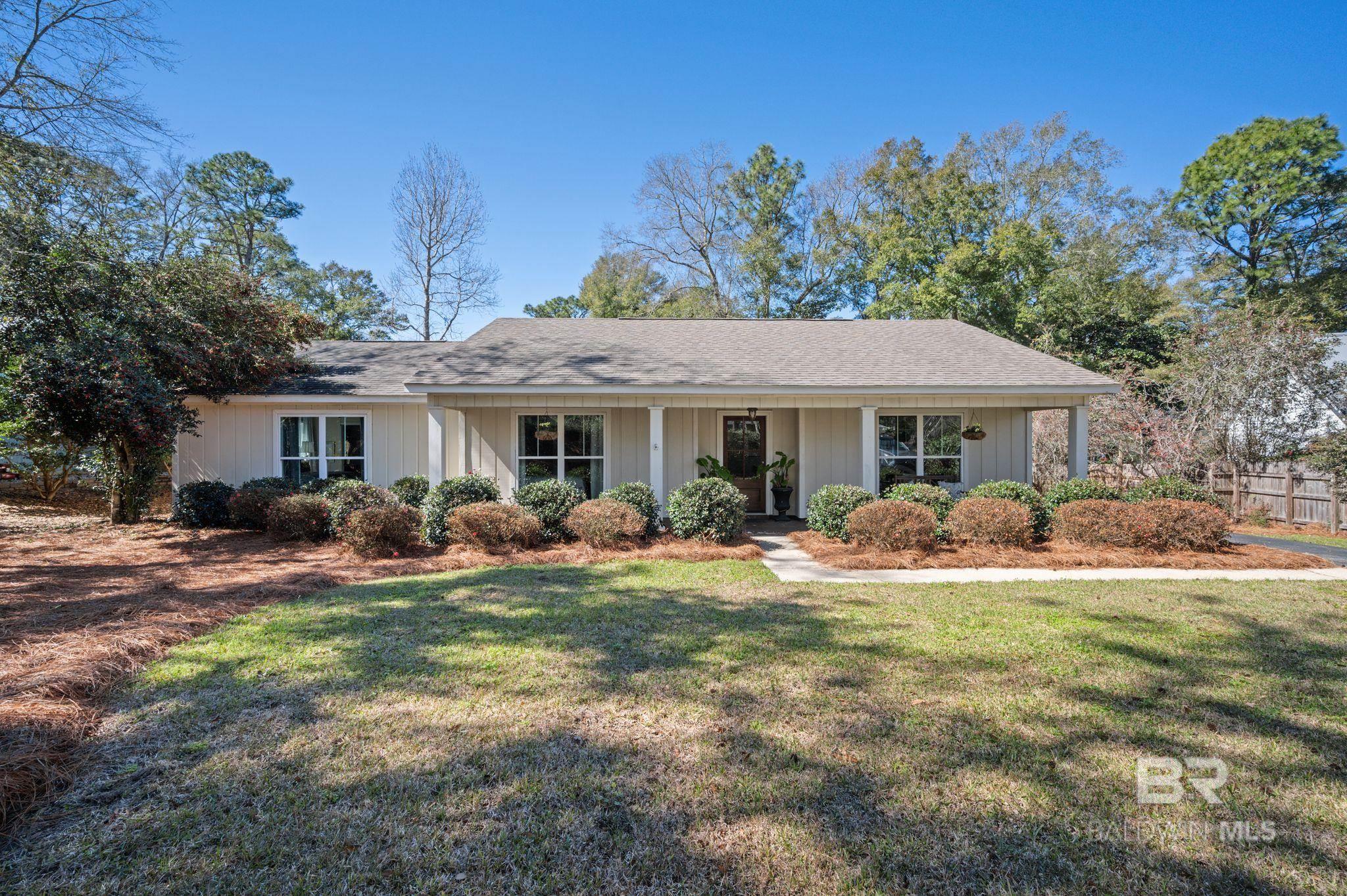 Welcome to one of the most charming homes in Fairhope! Tucked away on a quiet street, this residence offers two spacious living areas, three bedrooms, two bathrooms, and a combined eat-in kitchen, dining area, and breakfast nook. The back living area is a wonderful, cozy spot overlooking the back deck, while the front living area offers a great spot to read and relax. The bedrooms are all nicely aquainted, with the primary having an attached bathroom with double vanities. The two additional bedrooms offer an updated full guest bathroom. The backyard has been recently upgraded for your privacy and enjoyment, and the front yard beautifully blooms in the spring and summer. This delightful property adds a cheerful touch to everyday life. You will love the prime location - conveniently situated near downtown, grocery stores, and schools. Take a ride on your golf cart to dinner or walk to the nearby Fairhope West Elementary School. Buyer to verify all information during due diligence.