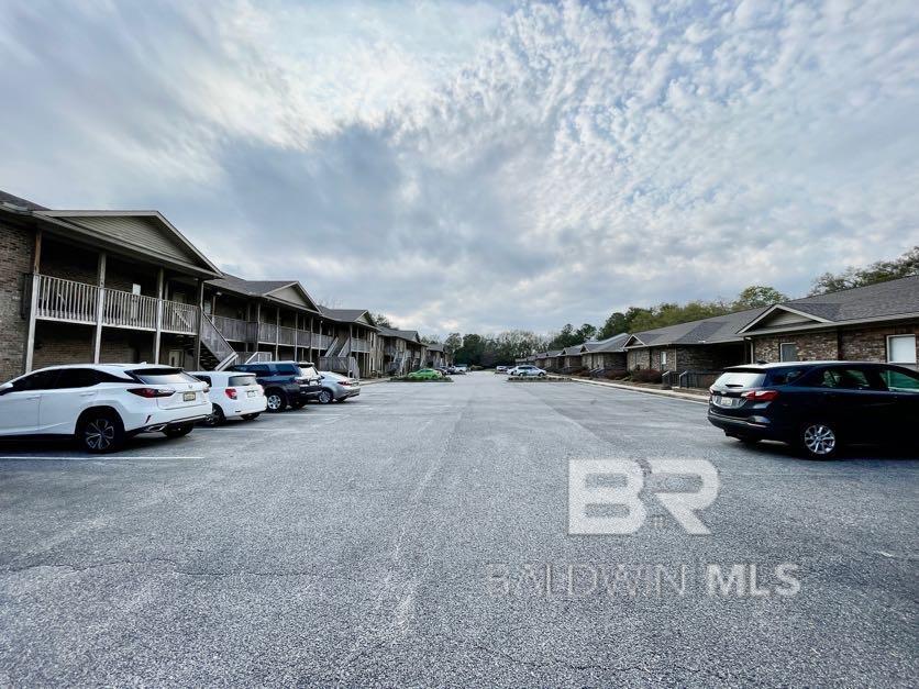 Quaint Fairhope condo, close to shopping and dining. Only 3 mile drive to downtown Fairhope.  Features include granite counter tops in kitchen and bathrooms; primary bedroom has en-suite bathroom and walk-in closet; 2nd bedroom has entry way to 2nd bathroom. Kitchen and living have a nice open plan. Upgrades include  2022 AC unit; 2024 laminated floors ; new microwave; new fans and light features; new blinds; Fresh coat of paint. Washer and Dryer-2023. HOA include community pool, exterior insurance, termite protection; exterior maintenance and landscaping. Nice storage closet outside balcony area. HOA replaced roof in 2023. Buyer to verify all information during due diligence period.  Buyer to verify all information during due diligence.
