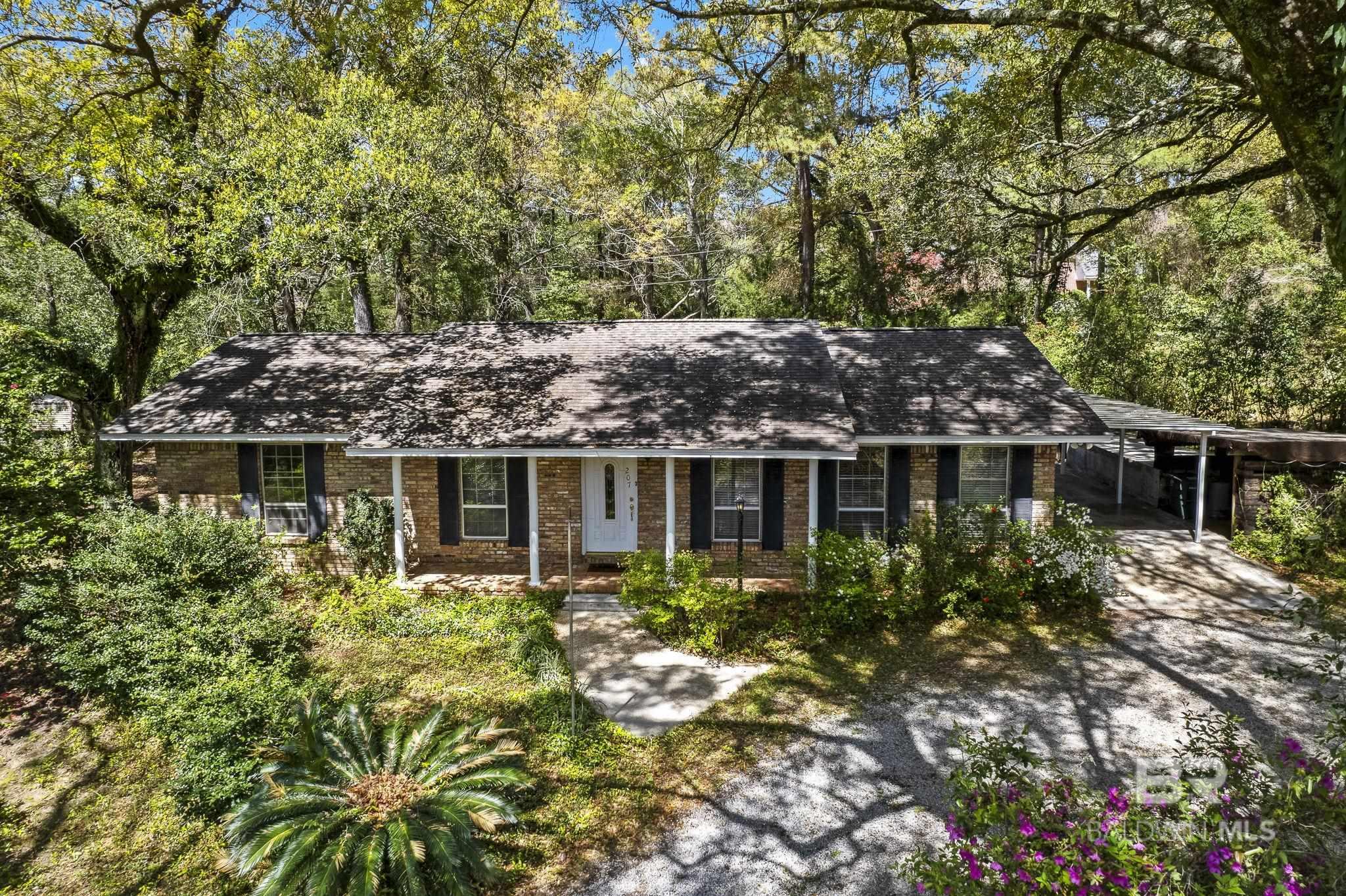 Double lot, solid brick, classic ranch home, with tons of potential that a ranch style provides, in the heart of Olde Towne Daphne!  Real wood tongue and groove kitchen walls with vintage cabinetry give this hidden gem the bay house feel of yesteryear! 300+ foot wide flat yard is booming with rare Mature heirloom,  azaleas and other flowering foliage. The property features a storm fortified cellar, new roof, and covered porches. For the creative, a potential development opportunity exists! Walk to Mobile Bay, shopping, restaurants, and parks! You can’t beat this location!  Schedule a tour today! Buyer to verify all information during due diligence.
