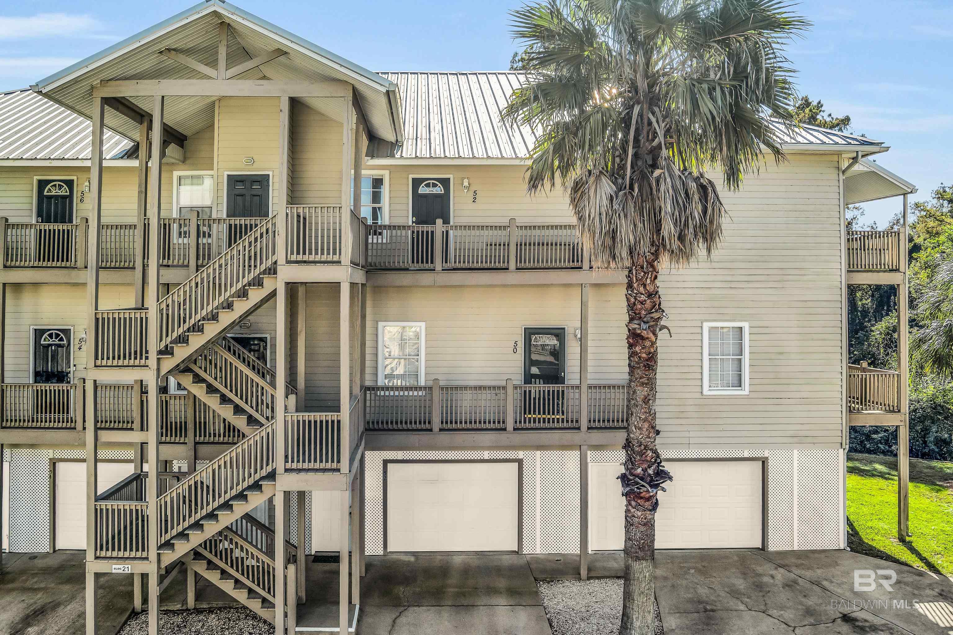Enjoy DIRECT VIEWS of MOBILE BAY and stunning SUNSETS from the LR, DR, Kitchen and primary bedroom! Savor your morning coffee and sunset dinners on the fully covered 36 ft Trex balcony.  In addition to being one of the few units that offers unobstructed views of the Bay, this condo is the only 2 BR / 2 Bath unit in the complex with over 1600 sf of living space. This unique unit also has a new HVAC (2024), low maintenance tile flooring, recessed lighting, crown molding, ceiling fans and custom Hunter Douglas window treatments throughout. It was also constructed with extra soundproof insulation in the floor. The spacious kitchen features abundant storage, a dining bar, stainless-steel appliances (2023), and beautiful Quartz countertops (2024). The large primary ensuite offers an oversized shower with built-in seat, a whirlpool tub, and a large walk-in closet with custom shelving. The second bedroom is also very spacious and features a built-in desk with quartz countertop. This room also makes a great office or 2nd den. The large laundry room is equipped with nice cabinets, a mud sink, a built-in ironing board, and even a custom faucet under the sink for cleaning the balcony or watering plants. There is also a conveniently placed water faucet on the back balcony. The oversized 2+ car garage offers abundant storage and is equipped with an enlarged garage door to facilitate parking vehicles side by side. You will also love the convenience of the shared exterior elevator (approx. 4 years old) that is located by the garage. All kitchen appliances and storage containers in the garage convey.  Rentals are restricted to a minimum of 6 months. Buyer to verify all information during due diligence.