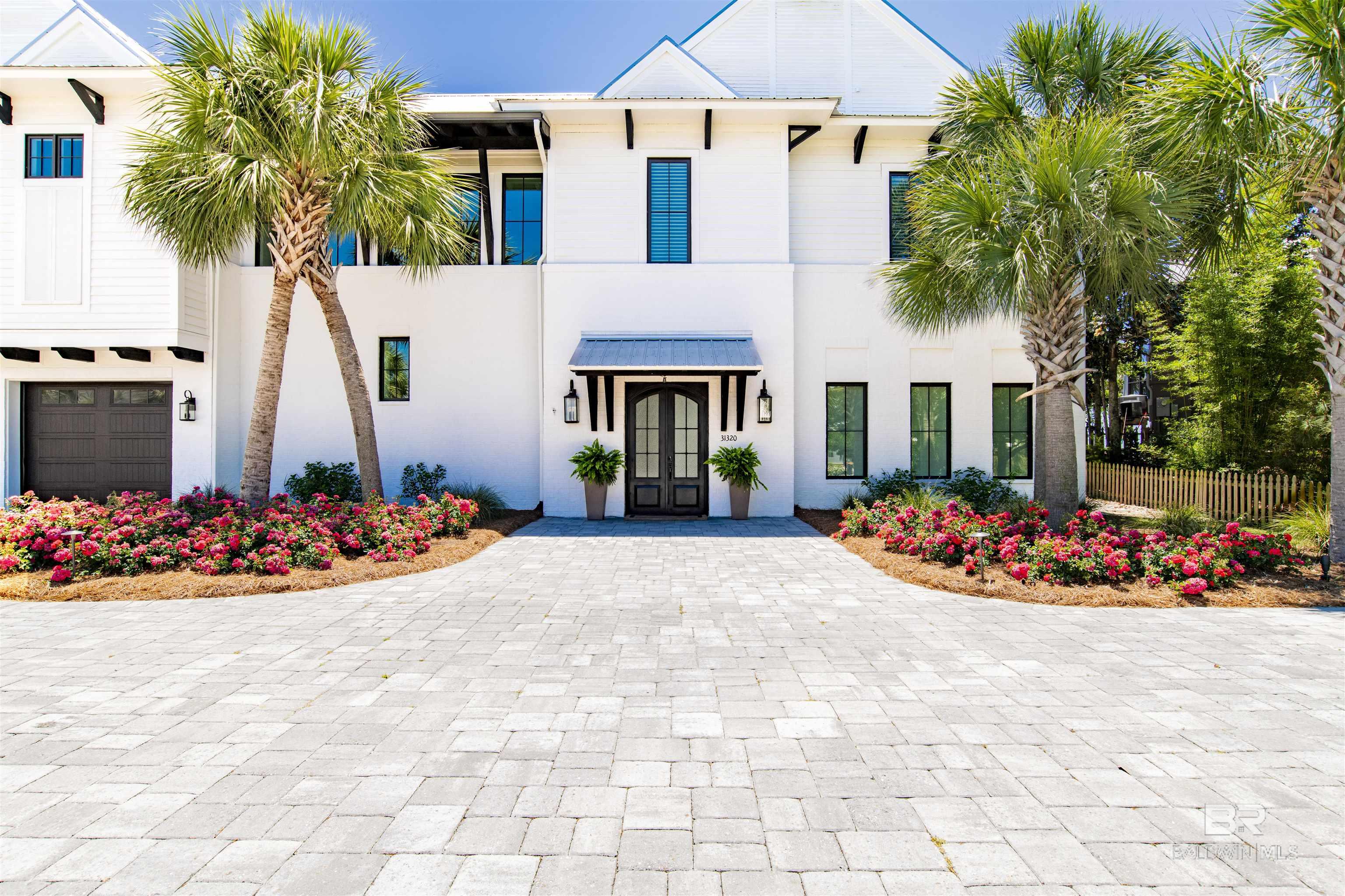 Located on one of the most coveted islands on the Gulf Coast, this modern masterpiece lies on one of the highest elevated lots on Ono Island. This beautiful gold fortified home crafted by McCollough Architecture and J L Loper boasts 100' of direct Old River frontage. Luxury permeates every inch of this home with six generous bedroom suites. The main level of the home overlooks Old River and has a well appointed poolside terrace, magnificent open great room with solid cypress beams and floor-to-ceiling sliding glass doors which seamlessly blend indoor and outdoor living, a spacious dining room and gourmet kitchen outfitted with top-of-the-line finishes and Thermador appliances. The main level also features a powder room, TWO private and luxurious PRIMARY BEDROOM SUITES with large walk-in closets, curbless showers and access to the poolside terrace and two extra guest bedrooms connected with a Jack and Jill bathroom. Descend the architecturally stunning staircase or take the ELEVATOR to find large foyers. The downstairs area has a spectacular THEATER MEDIA ROOM with seating for nine, a WINE TASTING CELLAR with large modern wine cooler, two additional bedroom suites and a MEDIA/GAME ROOM ensuring effortless entertaining, 1282 sf finished 4-CAR GARAGE WITH WORKSHOP, solid concrete walls with 12' encasements, and a 22K generator which serves the main level. A remarkable BOATHOUSE WITH 2 LIFTS 16,000-pound capacity boat lift, jet ski lift for two jet skis; premium flow-through decking and over 4.5 feet water depth completes this extraordinary offering. Peaceful, luxurious and spectacular. Buyer to verify all information during due diligence.