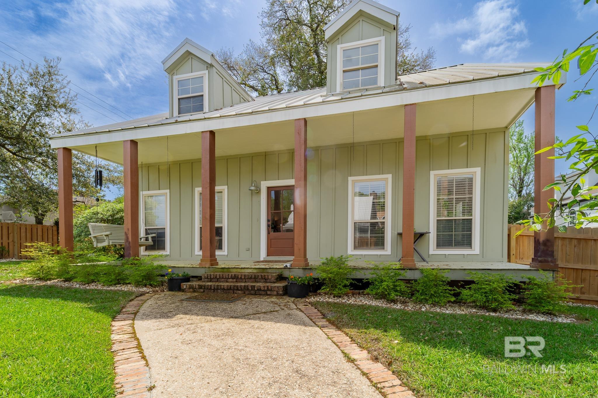 Spanning over 2,400 square feet, this beautifully updated 4-bedroom, 3-bathroom home is just steps from Mobile Bay and minutes from downtown Daphne's dining, parks, and more. With convenient boat launch access nearby, it’s perfect for those who enjoy coastal living. Inside, enjoy fresh flooring, new interior paint, updated electrical, and fully remodeled bathrooms—including two en-suite retreats. The expansive backyard is a standout feature, with meticulously landscaped grounds that enhance both privacy and curb appeal, creating an ideal space for relaxing or entertaining. A majestic oak tree and mature satsuma, lime, and banana trees add natural beauty and seasonal harvests to the backyard. A detached double garage offers ample storage and room for a workshop or additional vehicles. Move-in ready and perfectly located, this home is an exceptional find in a truly unique area. Buyer to verify all information during due diligence.