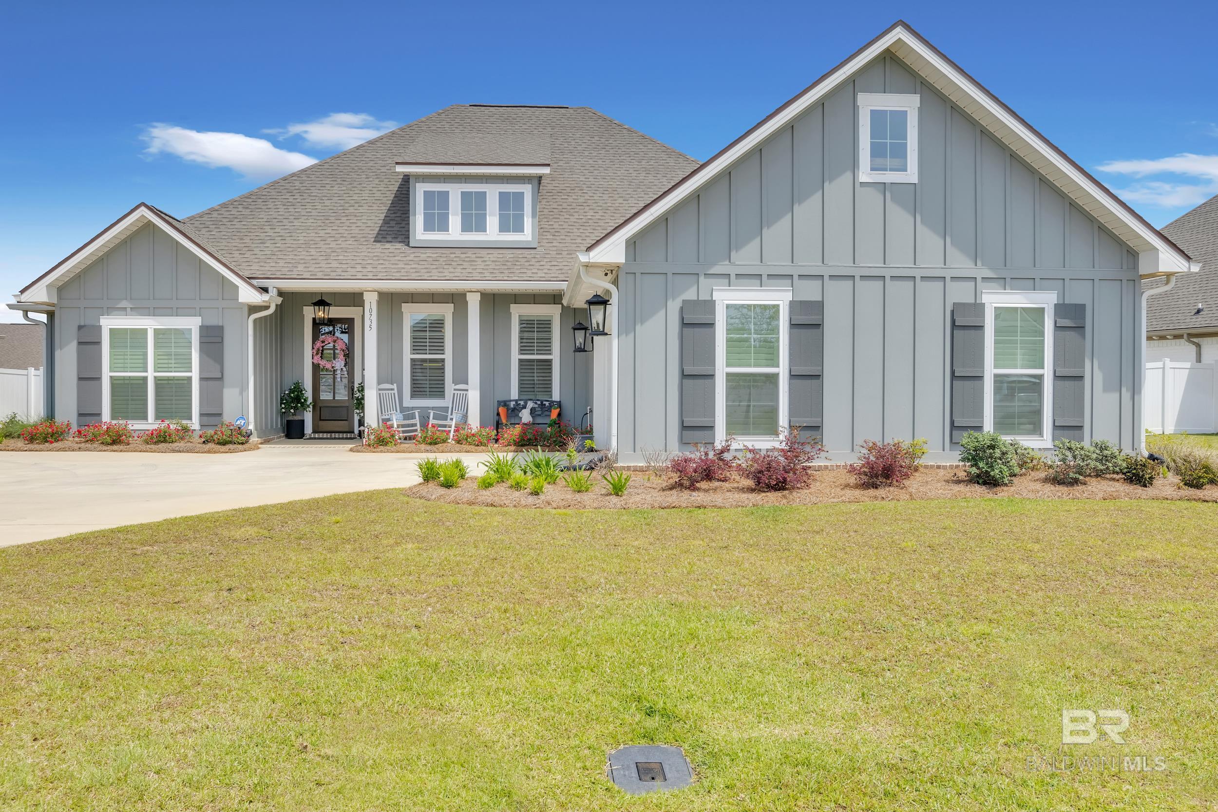 Built by Truland Homes, this like-new residence seamlessly blends space, functionality, and modern comfort—offering all the little luxuries that make a house feel like home. Step inside to be greeted by rich real hardwood floors and elegant custom craftsman-style millwork in the dining room, all complemented by plantation shutters throughout. The living room centers around a cozy gas fireplace and flows effortlessly into the gourmet kitchen, complete with a stone backsplash, quartz countertops, stainless steel appliances, and a spacious island that doubles as a breakfast bar—perfect for both entertaining and everyday living. The owner's suite is privately situated, creating a true retreat with tray ceilings, dual vanities with quartz counters, a soaking tub framed in stone, a separate tiled shower, and a generously sized closet with full-entry access and ample shelving. Two additional downstairs bedrooms share a well-appointed bathroom featuring dual vanities and a separate bath/shower area, ideal for comfort and convenience. Downstairs also offers a private guest powder room, full-entry pantry, desk area mudroom/drop areaUpstairs, you'll find a versatile fourth bedroom with its own full bath and closet—perfect for guests, a home office, or bonus living space. Outside, enjoy a large backyard, screened-in porch, exterior storage building, gold fortified roof, gutters, and a transferable termite bond for added peace of mind.  Buyer to verify all information during due diligence.