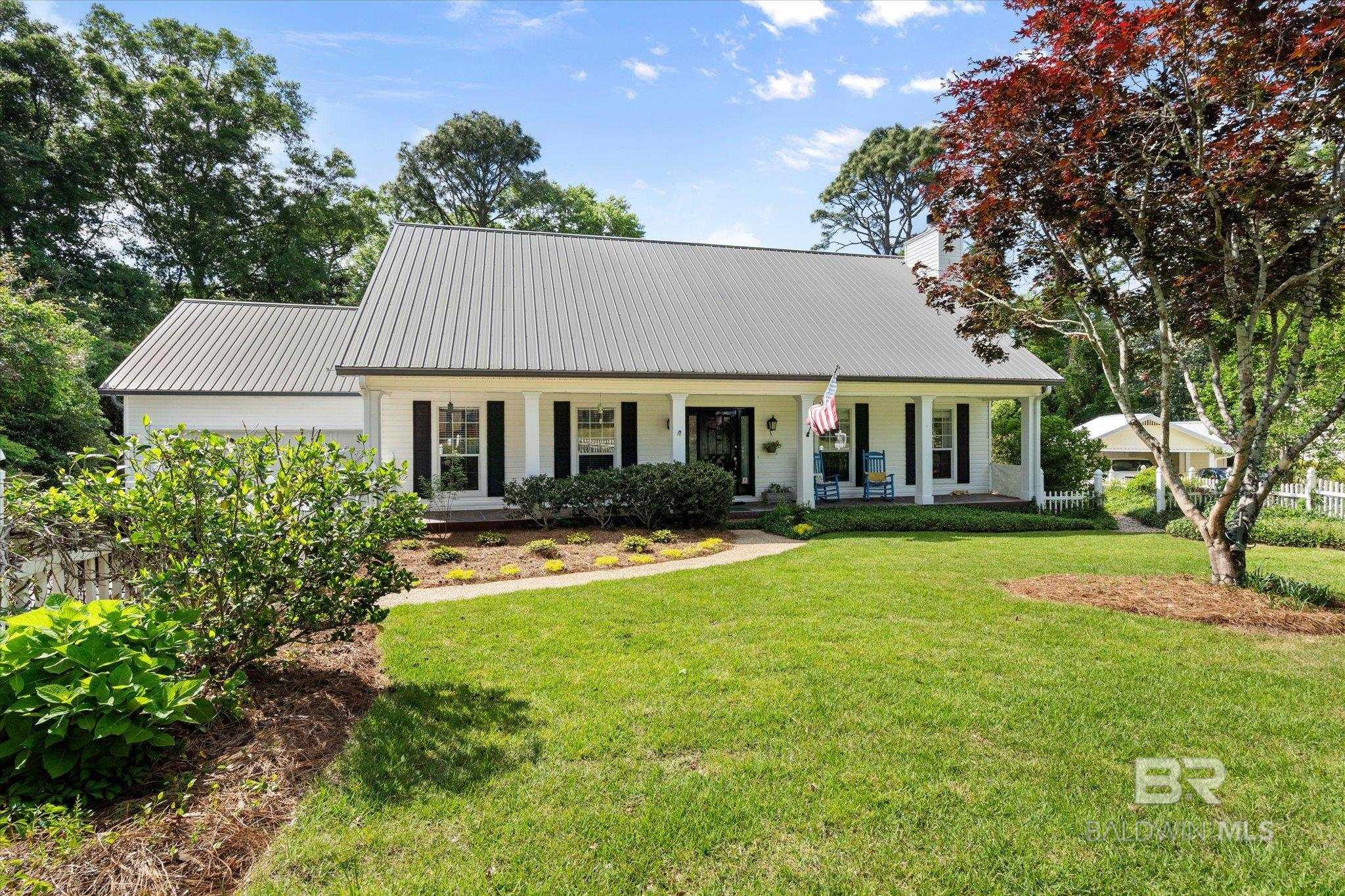 FANTASTIC FAIRHOPE LOCATION - NO HOA - DOUBLE GARAGE - POOL! Welcome to 121 Kurlane Street, where comfort, charm, and quality craftsmanship come together in this beautifully maintained, custom-built Creole-style home with a POOL! Ideally situated just minutes from Downtown Fairhope, this home offers the perfect blend of convenience and tranquility. The main level features a spacious primary suite with a generously sized ensuite bath. The large walk-in closet connects directly to the laundry room for added functionality. You'll enjoy the inviting living room, anchored by a beautiful fireplace with gas logs and brick surround, a dining room (or flex space), and a powder room for convenience. The thoughtfully designed kitchen has ample cabinet & counter space, as well as a cozy breakfast nook. Upstairs, you'll find three bedrooms, all with ample closet space, an updated full bathroom, and a large (19x21) heated & cooled bonus room with a sink. So many uses for this great space! Step outside to your private oasis: a newly built deck leads to a stunning 17x35 screened-in pool, offering the perfect space to relax without bugs (and the pool stays leaf-free). Enjoy peaceful evenings by the fire pit in the serene Zen Garden or utilize the large workshop (has power!) for projects or extra storage. The front yard has been freshly landscaped and sodded, enhancing the home's curb appeal. The attractive 50-year metal roof was installed in 2018, and the natural gas emergency generator system with transfer box make this house storm season ready! This exceptional property is a rare find in Fairhope - don't miss it! Buyer to verify all information during due diligence.