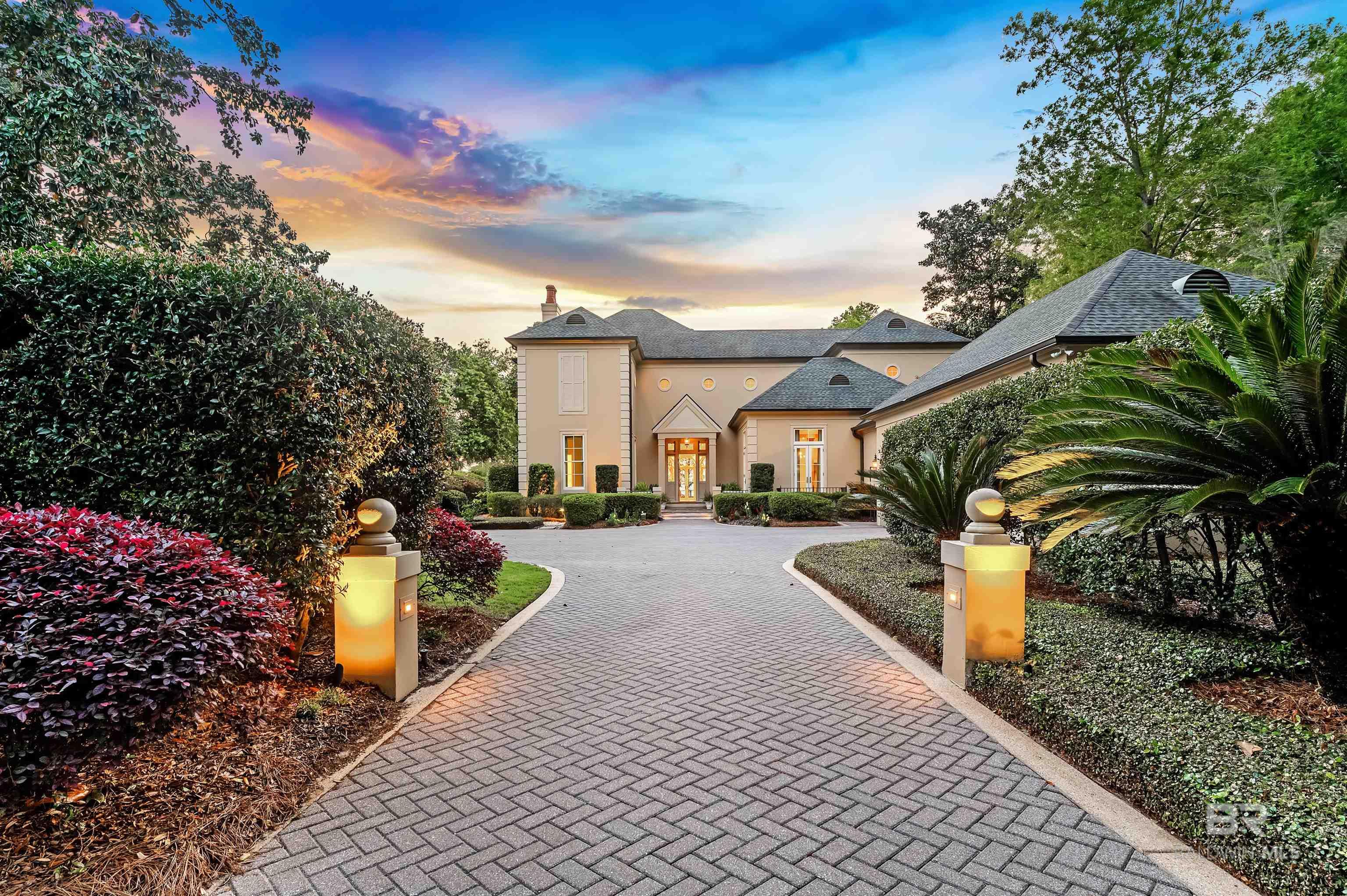 Luxury Bayfront Living in Montrose Village – A Timeless Retreat on Mobile Bay. Discover the pinnacle of elegance in this breathtaking 7,300+ sq. ft. estate with over 100’ on Mobile Bay, nestled in the heart of Montrose Village. This four-bedroom, five and-a-half-bathroom masterpiece seamlessly blends traditional charm with modern luxury, offering unparalleled views of Mobile Bay and easy access to downtown Mobile! Situated in Montrose Village, this exceptional home offers both privacy and convenience, with easy access to shopping, dining, and top-rated schools. From the moment you step inside, you’ll be captivated by gleaming marble floors, a grand entrance hall, walls of windows, soaring, 12’ ceilings, a grand staircase and exquisite craftsmanship by Bill Purvis. New roof installed in 2012. Features include: formal dining room that seats 12,  formal living room overlooking terraces & Bay, cozy keeping room off gourmet kitchen with Saltillo Mexican tile floors, walnut-paneled library/office with fireplace & wet bar, butler’s pantry, 2nd staircase, custom silk draperies, crown moldings and 10” baseboards, plantation shutters, elegant primary suite with fireplace, ensuite luxury bath, custom cabinets in huge walk-in closets, upstairs sitting room with terrace that overlooks pool and bay, stucco exterior, new tankless water heaters, new impact resistant windows & doors, herringbone pavers in driveway & parking courtyard, covered back porch, storage galore, and large courtyard between living room and kitchen wings. Step outside to your own private paradise, where a sparkling, heated pool, flagstone terrace, and cabana await. Surrounded by lush landscaping and serene bay views, evenings bring breathtaking sunsets that offer the perfect backdrop for relaxation on the spacious terrace or a leisurely stroll down the new Frank Potter-built pier to the boathouse. Experience the ultimate in waterfront living—schedule your private tour today! Some photos staged.  Buyer to verif