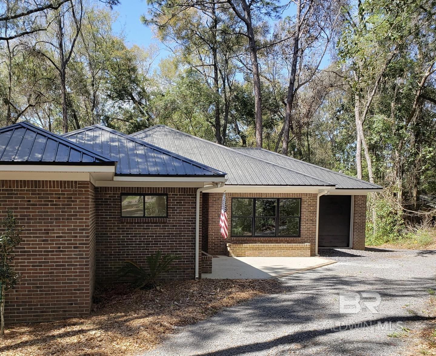 Brand new renovation in downtown Fairhope! Private home on deeded large lot just under 2 acres surrounded by nature's beauty within walking distance to downtown Fairhope. A must see! Bring your golf cart and enjoy the utopia of Fairhope living.  Open concept living. Lovely kitchen with porcelain counter tops. Recent additions include: New metal roof, HVAC, plumbing, electrical, natural gas tankless water heater, appliances, LVP flooring, kitchen cabinets, bathroom vanities, new lighting fixtues, floor to ceiling porcelain walls in primary bath. 9 foot ceilings throughout the home. Private porch off the primary bedroom and an additional huge wrap around back porch sure to enhance your outdoor living and entertaining. Study off great room could be used as another bedroom with separate entrance. Buyer to verify all information during due diligence.