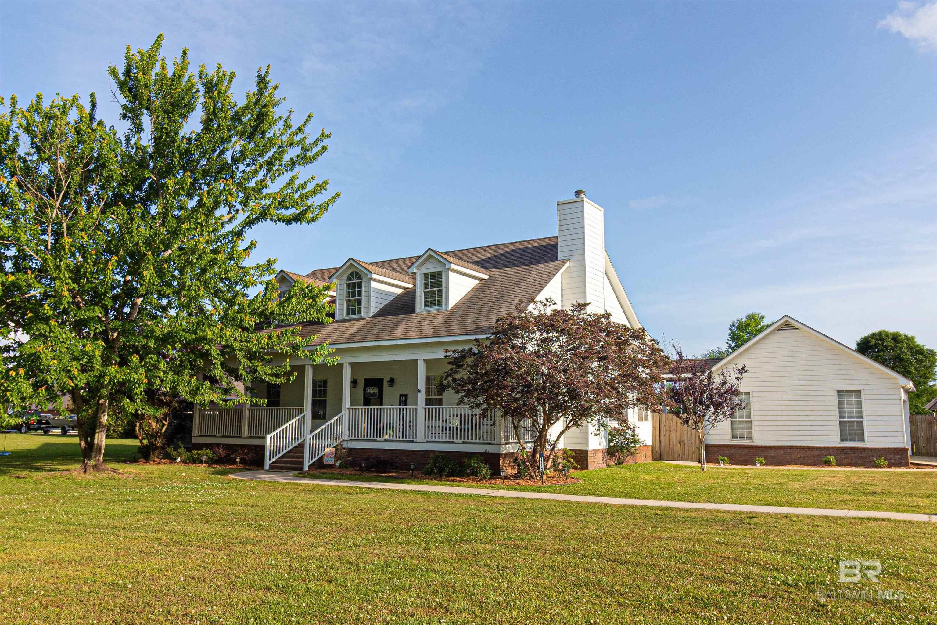 Welcome home to this lovely 5 bedroom 3 bath home on an acre of land and NO HOA. Enjoy the feeling of being in the country but close to everything!! There are so many great features including large front porch, large covered back deck, 2 car detached garage, 10'x16'storage building, Saltwater SWIMMING POOL with new pump, new light, new liner, diving board, slide, removable shade sail and removable pool fence,  new Hot Tub (2024)with covered pergola and more. Open, split floorpan with primary bedroom and two other bedrooms on the main floor with the remaining 2 large bedrooms upstairs with a bathroom and lots of extra storage space. The kitchen has granite countertops, gas cooking, plenty of cabinet space, bar seating, reverse osmosis filter on kitchen sink and refrigerator conveys. Separate Dining room and additional eat-in dining or breakfast/coffee nook overlooking the pool in the backyard. Upstairs finished out in 2023 with new HVAC(2023) downstairs HVAC (2020). Beautiful landscaping in the front and back and completely fenced backyard with fruit trees/plants throughout including: blackberries, grapes, blueberries, mulberry, apple, peach, pear, plum, nectarine and more. Gutters placed in 2023 and termite contract with Arrow Exterminators. Hurry, This one won't last long!! Buyer to verify all information during due diligence.