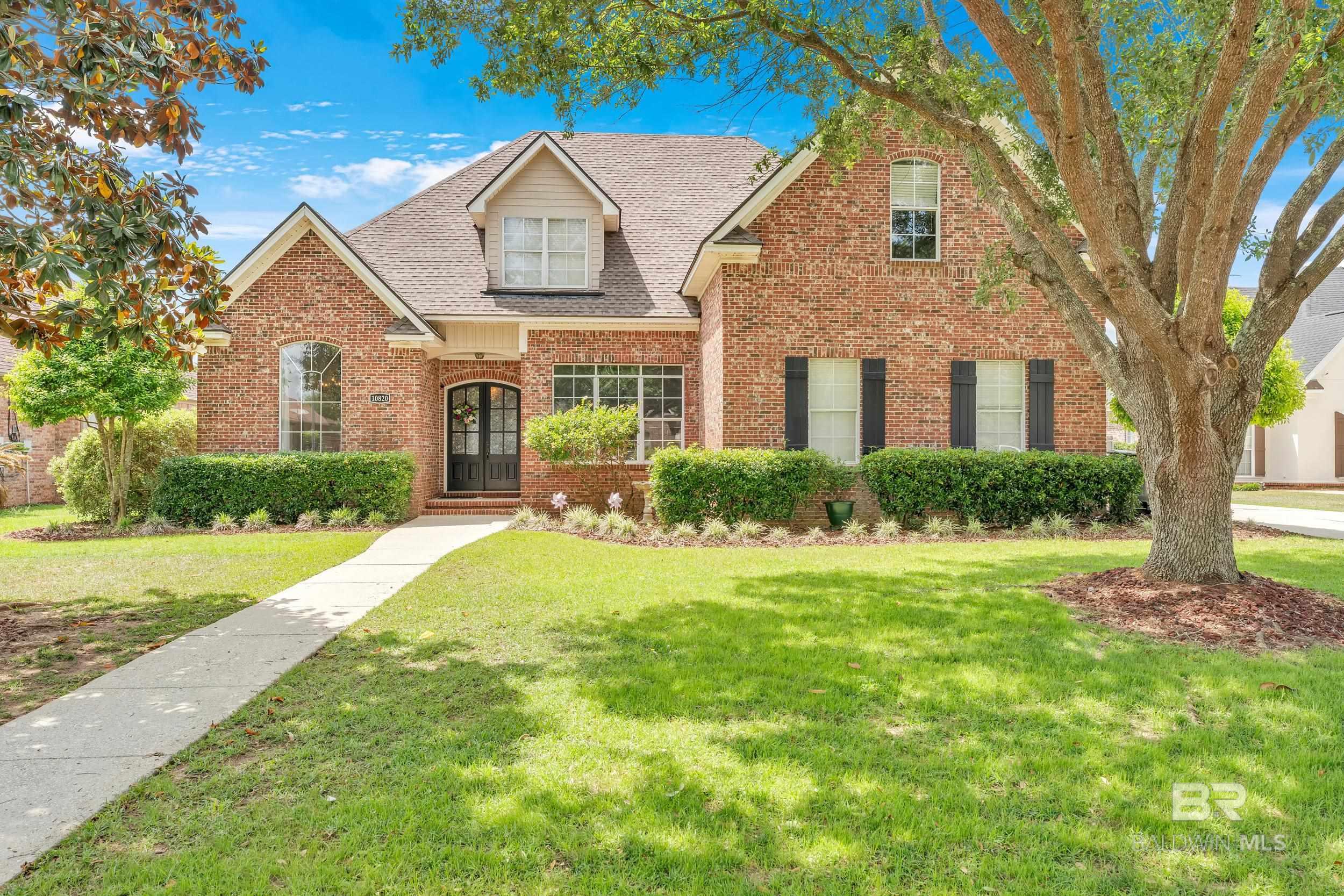 This truly custom-built home is packed with incredible features that are sure to impress. This beautiful two-story brick home offers a side-facing garage a true handyman’s dream complete with built-in shelving. Beautiful landscaping, and sprinkler system add to the curb appeal.  The front entry welcomes you with custom double doors leading into a true foyer a rare find. From there, you'll love the open floor plan, heavy trim package, 10-foot ceilings, rich wood flooring, & light-filled spaces thanks to abundant windows.  Designed for flexibility, this home easily accommodates a large family, hobbies, or work-from-home needs. On the main floor, you’ll find the primary suite an office plus a half bath.  The great room features high ceilings, wood floors, & a cozy fireplace, while the dining room is dressed with elegant heavy trim. The kitchen is a dream featuring raised-panel cabinetry, an abundance of storage, & a large pantry plus a pass through butler's pantry to dining room.  The primary suite is a retreat, with wood floors, a tray ceiling, recessed lighting, and a beautiful ensuite bath with double vanities, plenty of drawer space, a separate soaking tub, a luxurious tiled shower & a nice sized walk-in closet.  Upstairs, the secondary bedrooms are oversized with large closets and plenty of storage. One bedroom enjoys its own private bath, while the other two share a full bath. Don't forget to check out ALL of the attic storage plus closet space.  Step outside and prepare to fall in love with the expansive covered porch, complete with an outdoor kitchen & big screen TV perfect for entertaining or watching your favorite games. The large fenced backyard is beautifully landscaped & ready for you to enjoy plus has plenty of room for a pool. Neighborhood amenities include a pool, pond, playground & tennis/pickleball courts. *Fresh interior paint, a fortified roof, automatic attic fan & a new grinder pump. Located near Belforest School. Bu Buyer to verify all informatio