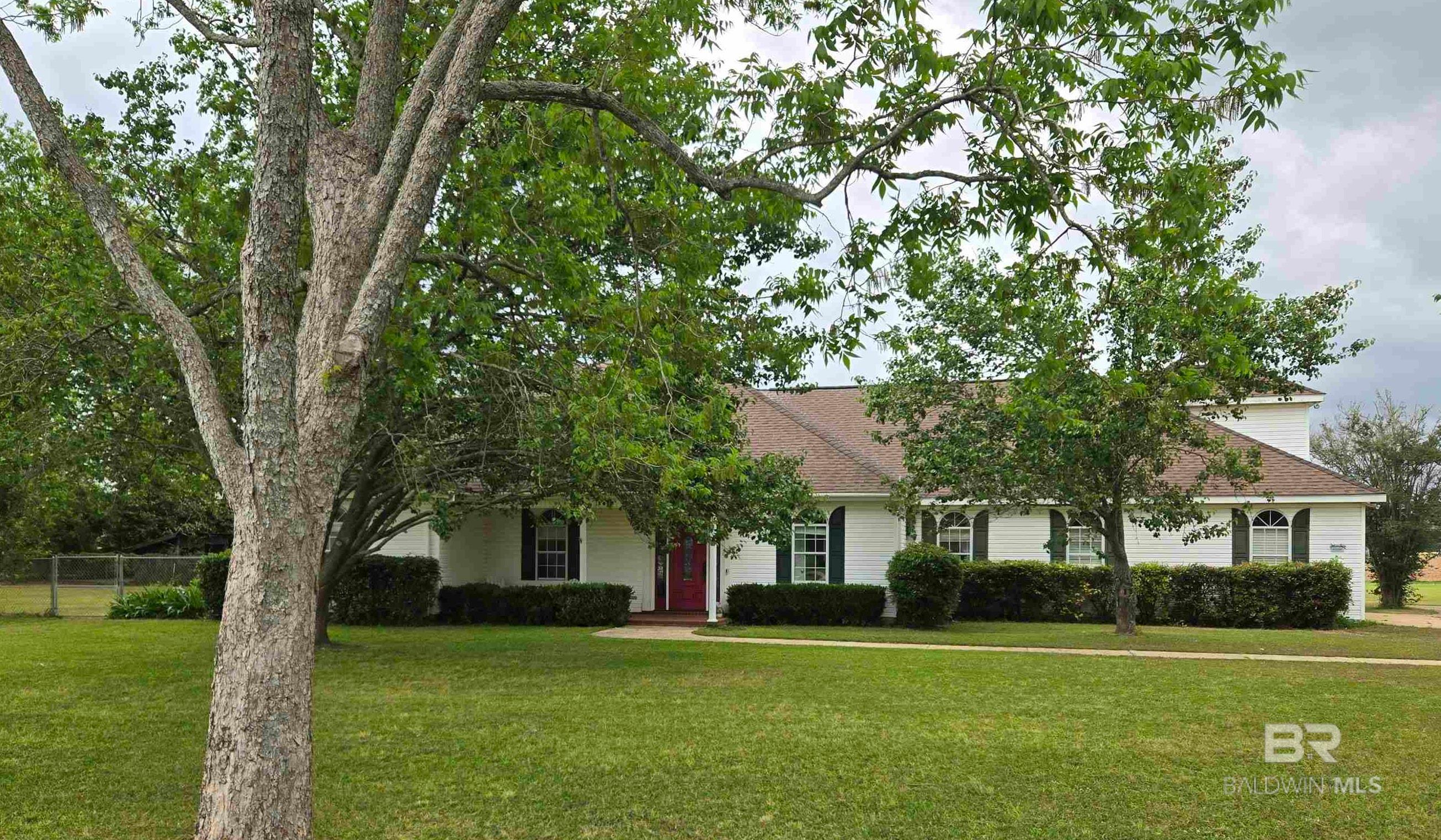 Welcome to your dream home in Daphne. Country living right in town with no HOA! This charming 4 bedroom with office and 3.5 bath retreat sits on a sprawling 1 acre lot. Beautiful landscaping includes multiple pecan trees and fruit trees. The spacious primary suite ensures relaxation. The finished large attic adds versatility, make it an extra office, bedroom, game room, make it your own. The eat-in kitchen provides the perfect space for family meals. The garage has been converted into a rec room with half bath. Enjoy morning coffee on the covered front porch or sweet tea on the back patio while the kids and pets play freely in the fenced yard. Plus, a .5 acre buildable lot offers endless possibilities. Don't miss the opportunity to own this unique property! Buyer to verify all pertinent information. Buyer to verify all information during due diligence.