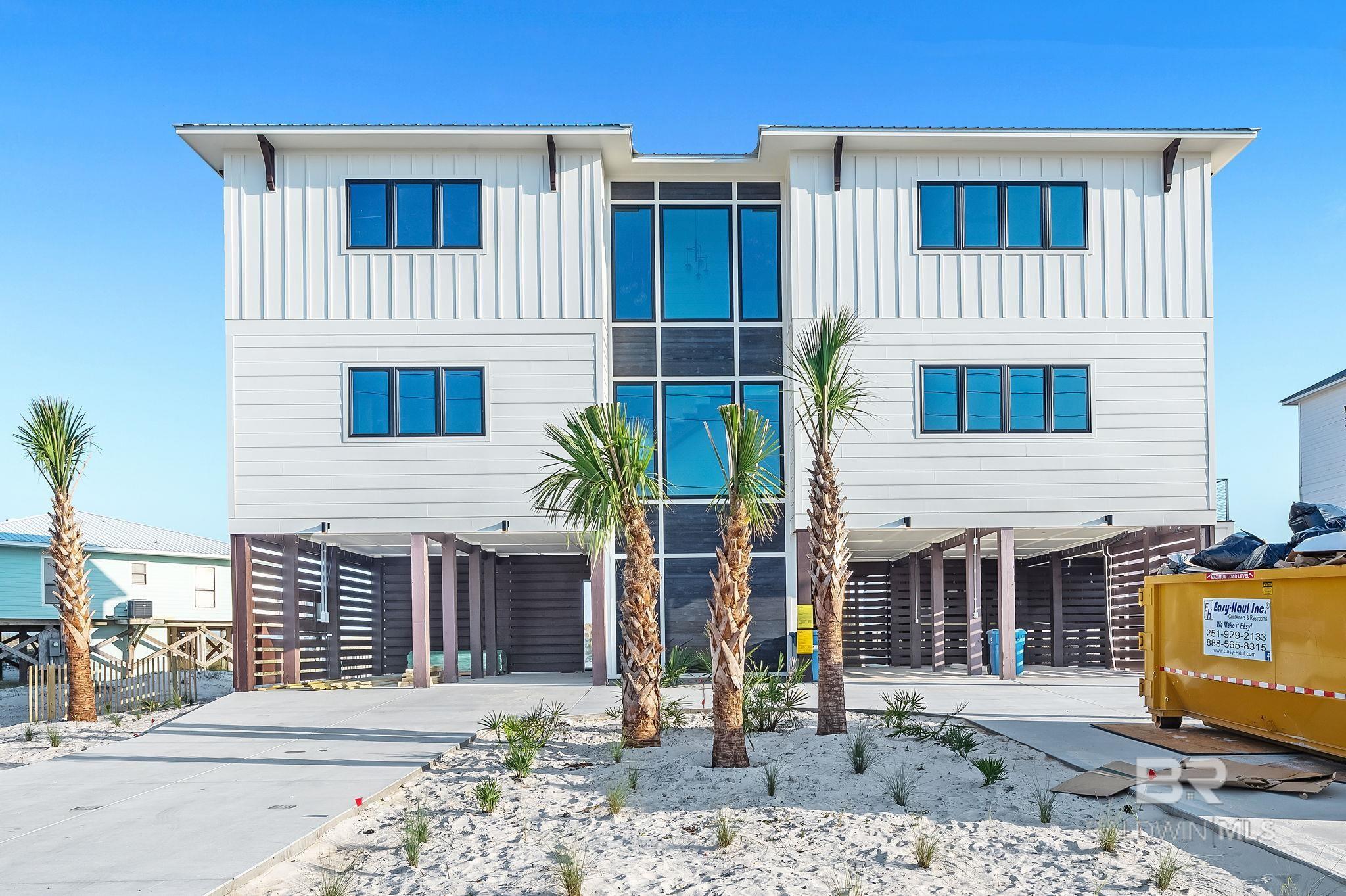 One-of-a-Kind Gold Fortified Gulf Front Beach Home – 7 Beds 7 Full + 2 Half Baths. 5,300 SF Sleeps 26 Discover a rare opportunity to own a breathtaking new construction Gulf-front estate on an oversized lot, offering 5,300 SF of luxury living. Designed to be a private oasis, an extraordinary second home, or a high-performing investment property, this stunning residence combines cutting-edge modern design with top-tier amenities and panoramic water views from every room. Sleeps 26 comfortably with spacious, well-appointed suites, including a large master with Gulf-facing deck, a luxurious en-suite bath with dual stone vanities, soaking tub, and glass shower. Family bedroom with king bed + 2 sets of bunk beds separated by barn doors perfect for guests of all ages. Direct private boardwalk to the beach with a unique split-stair design access from the pool or lower level. 12x22 propane-heated pool with a 20' bench for relaxing soaks. Over 1,200 SF of decks with stainless steel railings and CoolTeck decking for heat control. Lower-level lounge retreat with 80” drop-down TV, ping pong, couches, fire pit, outdoor shower, and a convenient half bath. Custom kitchen with wet bar, full-size refrigerator and freezer, dual dishwashers, 48” gas range, ice maker, beverage center, and walk-in pantry. Stunning 10’ waterfall island with under-lighting and coffered ceiling with accent lighting. Seating for 26+ across two dining tables and the island, entertaining is effortless. Wide plank white oak engineered hardwood floors, Floating staircase and glass-walled circular elevator, a showpiece of architectural design. 10’ ceilings on main and second floors, 12’ ceilings on lower level. Sound system in all common areas and decks. 80” TV above a three-sided electric mist flame fireplace in the great room.  Every detail of this one-of-a-kind coastal retreat has been meticulously crafted for the ultimate beach lifestyle. Buyer to verify all information during due diligence period. Buyer to
