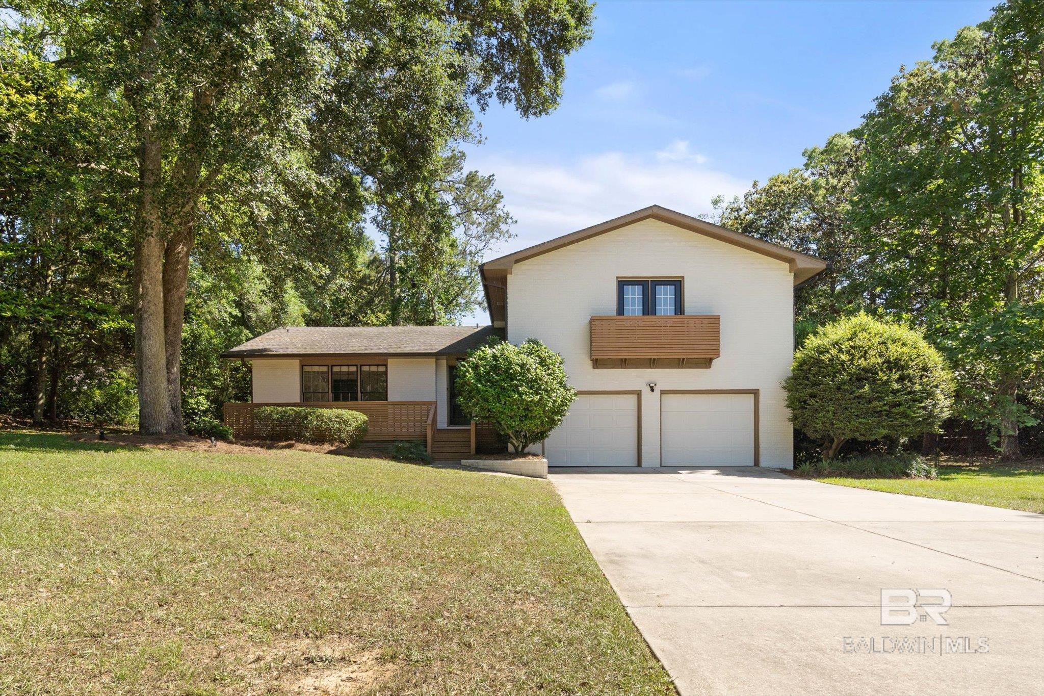 Tucked away on a serene street in the highly sought-after Fruit and Nut District of Fairhope, this timeless multi-level ranch-style home exudes warmth, character, and classic Southern charm. Built in 1971 and thoughtfully updated, this 4 bedroom, 2.5 bathroom home sits proudly on a rare double lot, offering space and a truly peaceful setting- with no HOA to limit your vision or lifestyle. As you approach, you are welcomed by mature landscaping. Inside, you will find stunning hardwood floors, a spacious living room, a separate dining room, a timeless kitchen with tasteful updates, and a cozy den with a wood-burning fireplace and French doors leading from this welcoming space out to the back patio and expansive backyard, connecting indoor and outdoor living. Perfect for year-round entertaining. Enjoy peace of mind with new kitchen appliances installed 2024,  a new tankless water heater and HVAC installed in 2024. Just minutes to downtown Fairhope, with walkable access to local shops, restaurants, and the city’s iconic festivals and events. This is more than a home; it is a lifestyle. Buyer to verify all information during due diligence.