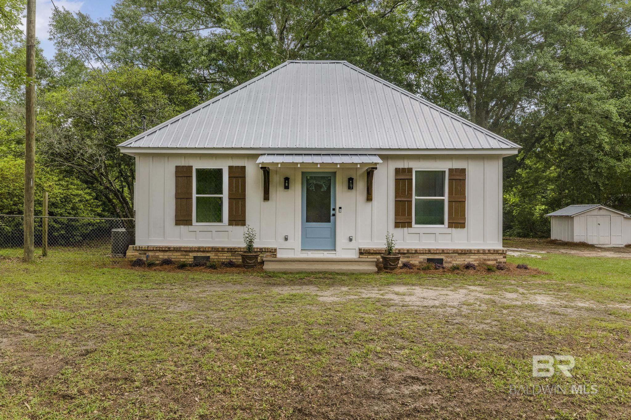 Welcome to this charming craftsman-style cottage on a quiet street just outside downtown Loxley. Set on a large, level lot with no HOA, this move-in-ready gem is full of thoughtful upgrades and Southern character. The home features a new metal roof added in 2022, new Hardie board siding from 2021, and a freshly repainted and caulked exterior in 2025. Inside, you'll find stunning real pine floors crafted from 1x12 planks, split brick in the entryway and bathroom, and a full electrical and plumbing update completed in 2021. The home also includes new subflooring, attic insulation, and a Ring doorbell for added convenience. Currently set up as a 1-bedroom, 1-bathroom home, the spacious extra room is being used as a large closet and laundry room—but with a separate laundry area located inside the oversized pantry, it could easily be converted into a second bedroom. Outdoors, the fenced backyard is perfect for pets and entertaining, complete with hot and cold water spigots near the back door—ideal for adding an outdoor shower. A storage shed with a new roof and siding in 2025, plus electrical and a window unit A/C, adds even more function and flexibility. Whether you're looking for a cozy primary residence, a weekend retreat, or a smart downsize, this centrally located property just off Hwy 59 offers quick access to I-10 and the sugar-white sands of the Alabama Gulf Coast. Buyer to verify all information during due diligence.