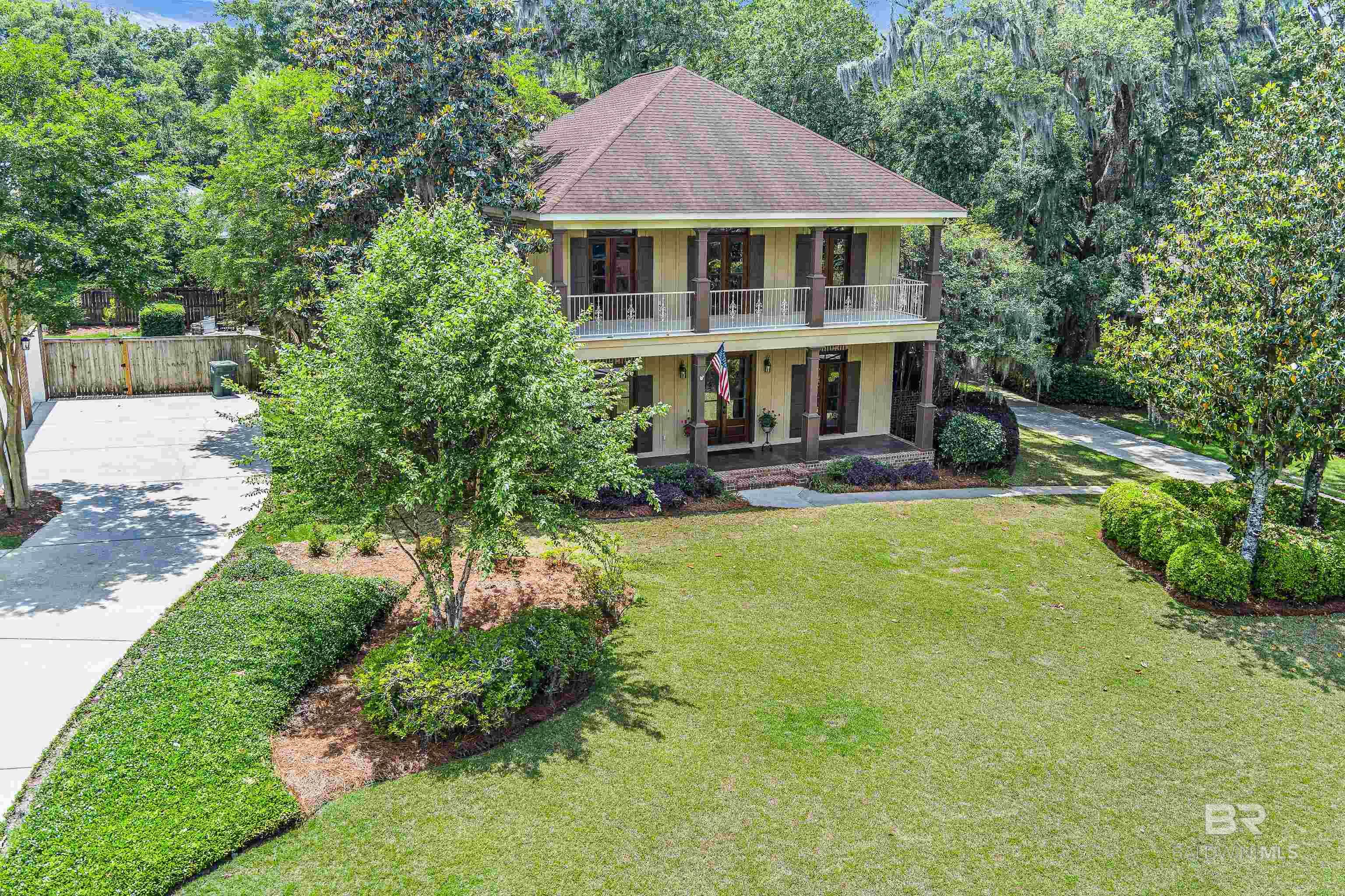Stunning New Orleans style home nestled in one of Old Town Daphne’s most beautiful neighborhoods with DEEDED BAY ACCESS, community pier, pavilion and beach area. The main level of this custom 5 BR / 3.5 bath home offers 10 ft ceilings, beautiful wood flooring, an oversized primary ensuite with huge walk-in closet, an inspiring office, and half bath. The Chef's Kitchen features a Thermador gas range, Bosch dishwasher, granite counters, abundant cabinetry, a breakfast area, and a spacious pantry. The well-designed floor plan offers great flow from the kitchen to both the dining room and living room. Extend your entertaining to the screened porch or just relax and enjoy the ambiance of the dual sided fireplace. The 2nd level offers 9 ft ceilings with a Jack and Jill Suite plus 2 more bedrooms that share a hall bath. One of these bedrooms provides balcony access with incredible views and currently serves as a 2nd home office. In addition to an attached 2 car garage, the property also offers a detached 12 x 15 insulated Golf Cart garage or workshop with electricity. Stroll or ride your golf cart down the wooden bridge through a lush, serene nature trail where you can enjoy the soothing sounds of the bay, catch fish and trap crab on the 2-level pier. Of course, you can also experience fabulous sunsets & fireworks over Mobile Bay on the 4th of July. The home also has a NEWER ROOF (2019), and a separate water meter for irrigation. The beach pavilion can be reserved for private gatherings. The Harbor Place neighborhood entrance also offers video camera security, and the association even provides a conveniently located port-a-potty (maintained weekly) for the bay access. Buyer to verify all information during due diligence.