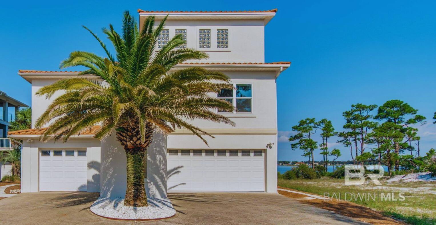 WATERFRONT ESTATE 1.56 acres!  Discover the ultimate waterfront opportunity in the heart of Perdido Key, Florida! This rare offering combines a luxurious 3-bedroom, 2-bath waterfront home plus an adjacent .81-acre vacant waterfront lot on River Road, creating a unique chance to own over 150 feet of premier waterfront property. While the owner is willing to sell the properties separately, purchasing them together opens endless possibilities for creating your dream coastal estate.This luxurious waterfront residence features deep water access, a private dock with a covered boat lift, and breathtaking views of Old River. The open floor plan includes a spacious living area, a modern kitchen with new appliances, and a master suite with a private waterfront balcony. Updates like a new roof (2021) and fresh exterior paint ensure move-in readiness. Additional perks include a versatile bonus room, and ample garage space. This home was untouched by storm waters during Hurricanes Sally and Ivan . The adjacent .81-acre (75-foot waterfront) vacant lot offers stunning sunset views. Ideal for a large private dock, this deep-water lot previously accommodated a 58-foot yacht. Located steps from the beach and local favorites, it’s a perfect blank canvas for a custom waterfront home, all with no HOA restrictions.Whether you’re seeking a luxurious coastal retreat, an investment opportunity, or a combination, this offering has it all. Build a second custom property on the adjacent lot or enjoy the flexibility of having two separate waterfront parcels.  Don’t miss this once-in-a-generation opportunity to own a combined waterfront property with unparalleled potential. Contact us today to schedule your private tour! Buyer to verify all information during due diligence.