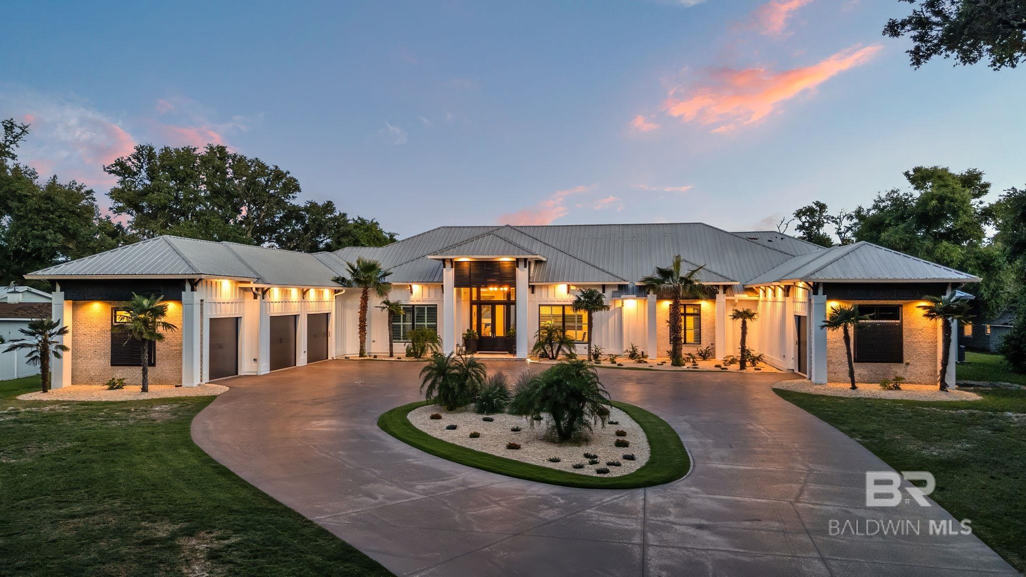 Where Coastal Elegance Meets Timeless Luxury.   This 7BR/8BA + 2 half-bath waterfront estate is the epitome of coastal sophistication. Set on elevated ground with 190' of private beach and a 2021 dock upgrade that includes flow-through decking and has deep-water access, this smart home features a chef’s kitchen with Thermador appliances, his-and-hers offices, game room, 140 inch screen theater, safe room, and custom security system. In the heart of this exquisite home you will find the 1400 gallon custom built salt water aquarium. Enjoy a 9 foot deep, chilled and heated, saltwater pool, 10x10 spa, and full outdoor kitchen, all designed for flawless indoor-outdoor living. This is more than a home- it's a lifestyle. Every detail has been meticulously curated to offer a seamless blend of luxury, comfort and refinement, allowing you to fully relax and enjoy the essence of paradise. Buyer to verify all information during due diligence.