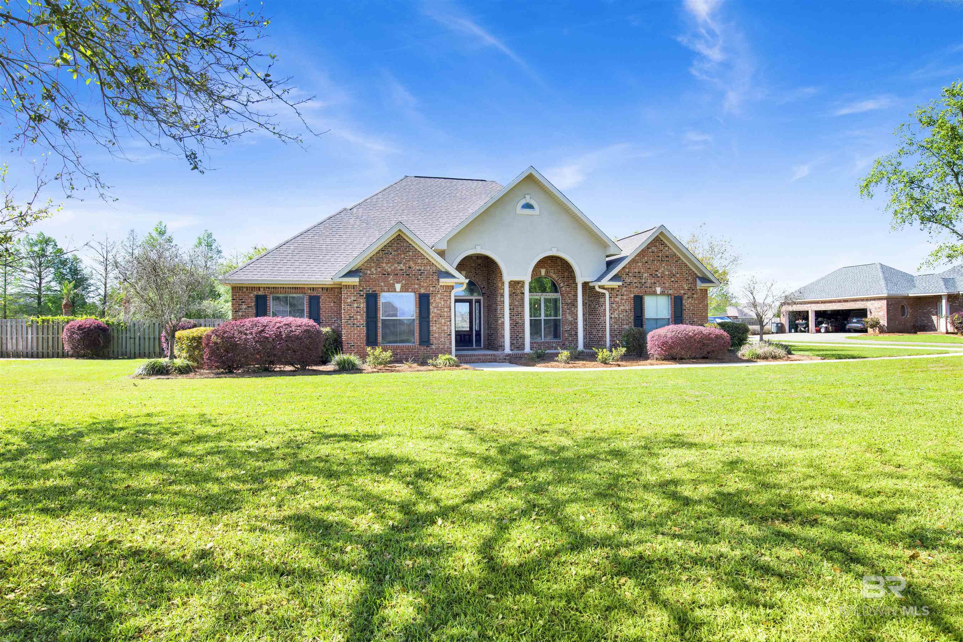 Custom Home in Desirable Avalon Subdivision. This 4 bed 3 bath PLUS an upstairs bonus room above the garage with a half bath, perfect for a home office, media room, or guest space. This open floorplan offers the perfect blend of comfort, style, and functionality. Step inside to find beautiful hardwood floors, crown molding, high ceilings, and thoughtful touches like a dry bar, ideal for entertaining or relaxing evenings at home. The chefs kitchen features granite countertops, custom wood cabinetry, stainless steel appliances and a gas cooktop, perfect for entertaining.  The large primary suite is a private retreat, featuring dual walk-in closets, and a beautiful en-suite bathroom with dual vanities, jetted soaking tub, separate shower with rain head, and a hand held sprayer.  Additional highlights include a large laundry room (Washer and Dryer to convey) with adjacent utility space and sink, with abundant storage.  Home includes a bronze fortified roof, two HVAC units (2020), smart thermostats, irrigation system, and more.  Enjoy outdoor living on almost an acre lot, with a charming front porch, a screened back patio, and a fully fenced backyard with plenty of room to add a swimming pool. Outdoor storage building with power adds even more functionality. The exterior features classic brick with a stucco finish and eye-catching weeping mortar detail that adds character and curb appeal.  With a spacious three-car garage, and a floor plan designed for everyday living and entertaining, this is truly a home that has it all. Come experience the space, comfort, and warmth this home offers—schedule your private tour today! Buyer to verify all information during due diligence.
