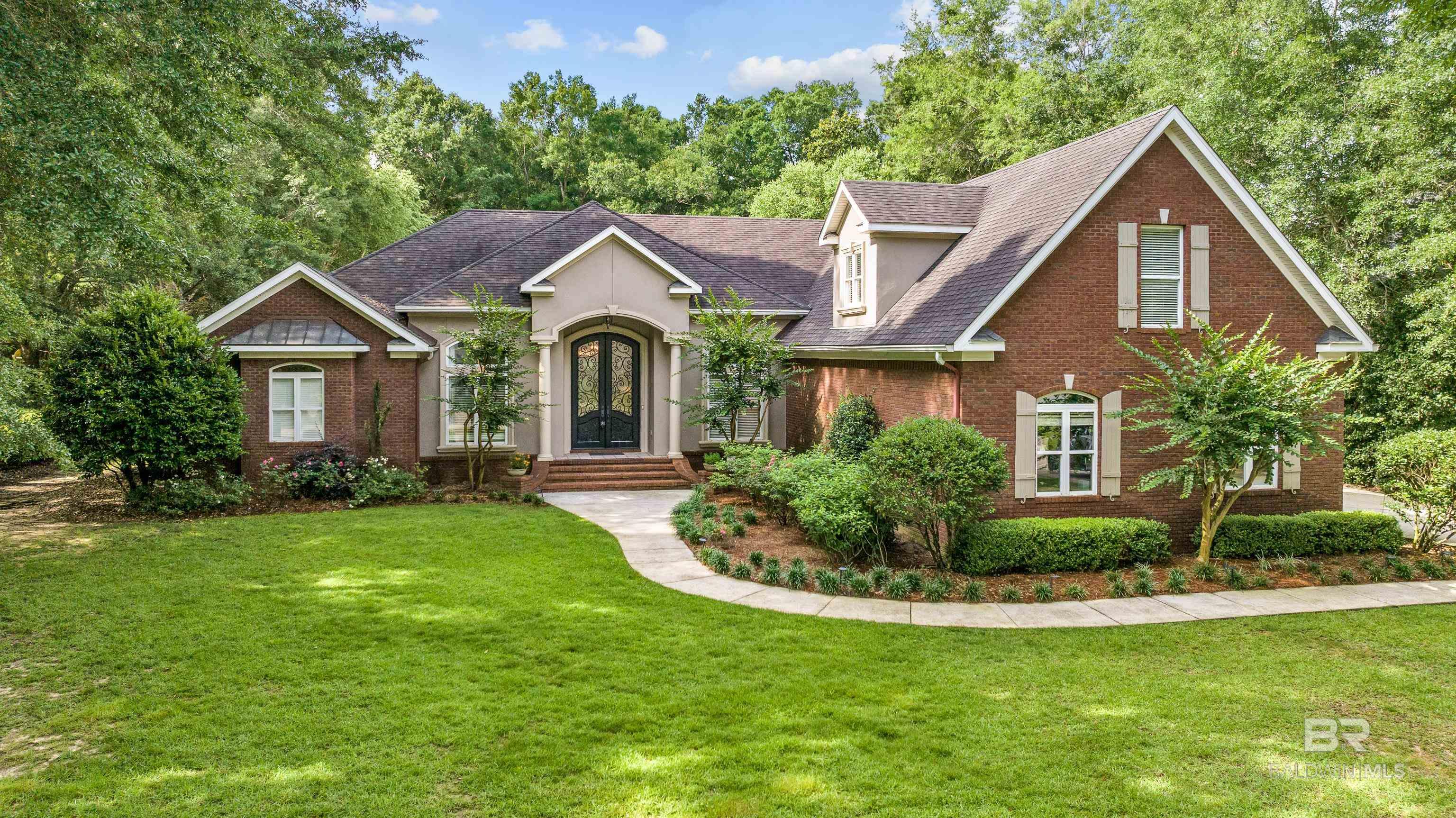 Don’t miss this well-designed, ONE LEVEL living home, nestled on almost 1-acre, fenced lot, with a SWIMMING POOL & SPA, 3 CAR GARAGE and loads of STORAGE! Woodlands at Malbis is a special, mature, one street neighborhood, in a convenient location, just minutes to shopping, dining and I-10. This home offers one level living, with NO CARPET downstairs, with a Media room/flex/guest suite upstairs with a full bath and mini fridge. Enter the stunning 10-foot custom front doors, into a grand foyer that sets the tone for the rest of the home. Just off the entry, you’ll find an executive-caliber office, a welcoming living room w/fireplace, and a formal dining room featuring a nice wet bar w/cabinetry & built-in ice maker—perfect for hosting guests!  Gourmet kitchen with high end appliances, double ovens, 5 burner gas cook top, abundant custom cabinetry, island with sink, walk in pantry and a wraparound granite bar that opens into a cozy keeping room with its own fireplace. The spacious master suite boasts a tray ceiling with recessed lighting and a spa-like bathroom featuring large dual walk-in closets and antique claw-foot tub. All 4 bedrooms downstairs have hardwood floors and en-suite baths. Spacious laundry room with counter space, cabinets and sink. The best part is when you walk out the French doors to the expansive covered porch, a gorgeous pool with hot tub, outdoor kitchen, plus gas fire pit, over looking private, beautifully landscaped backyard. Additional features: Spacious 3-car garage w/storage closet, 220V outlet, wash sink, built-in work bench, partial GENERATOR w/backup power, WALK IN ATTIC ACCESS. House and IRRIGATION runs on WELL WATER with city water access available. This one-of-a-kind home effortlessly blends luxury, comfort, and privacy! Buyer to verify all information during due diligence.