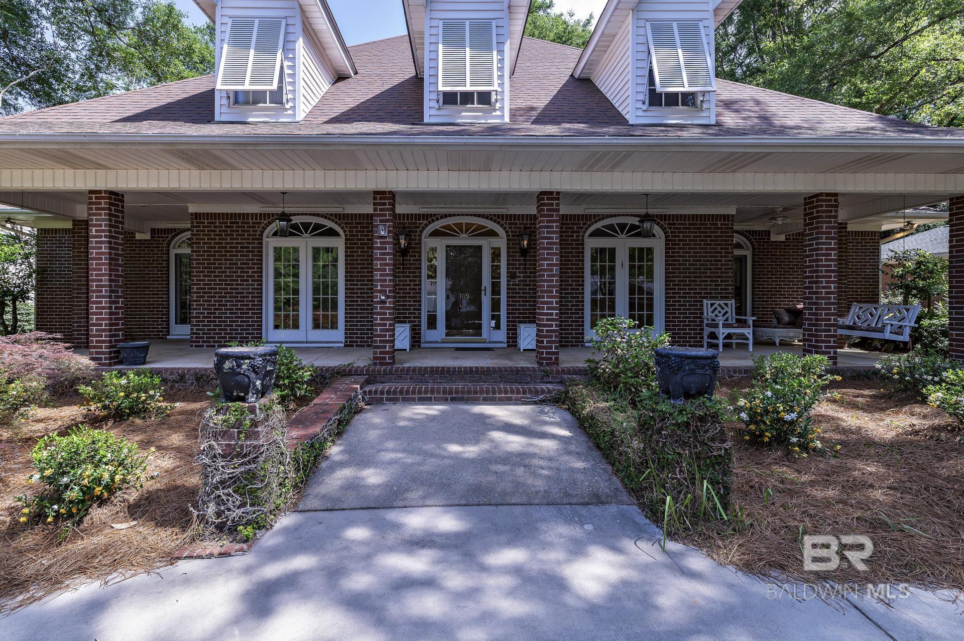Expansive Custom Home with Exceptional Potential – Located in the coveted Oak Bluff Estates subdivision within the highly sought-after Olde Towne Daphne area, this spacious 4-bedroom, 3.5-bath home offers over 3,500 square feet of well-designed living space. The thoughtful floor plan features a main-level primary suite, with three additional bedrooms upstairs, providing comfort and flexibility for families of all sizes.Enjoy a variety of living spaces including a formal dining room, cozy den with fireplace, sunroom, and a formal sitting room—ideal as a home office or reading retreat. Notable updates include a new roof (2020), main-level water heater (2022), updated HVAC systems (2023), Upstairs water heater (2025) and a whole-house generator installed in 2024. Situated on a beautifully landscaped 17,600 sq ft lot, the property also features a private, fenced backyard and a rear patio perfect for outdoor entertaining.This home is being sold as-is, but has been well maintained with key improvements already completed, offering excellent value and a rare opportunity to add your personal finishing touches. Located close to top-rated schools, shopping, and the scenic shores of Mobile Bay, this home blends space, location, and potential like no other.Don’t miss your chance to own a custom home in one of Daphne’s most desirable neighborhoods! Buyer to verify all information during due diligence.