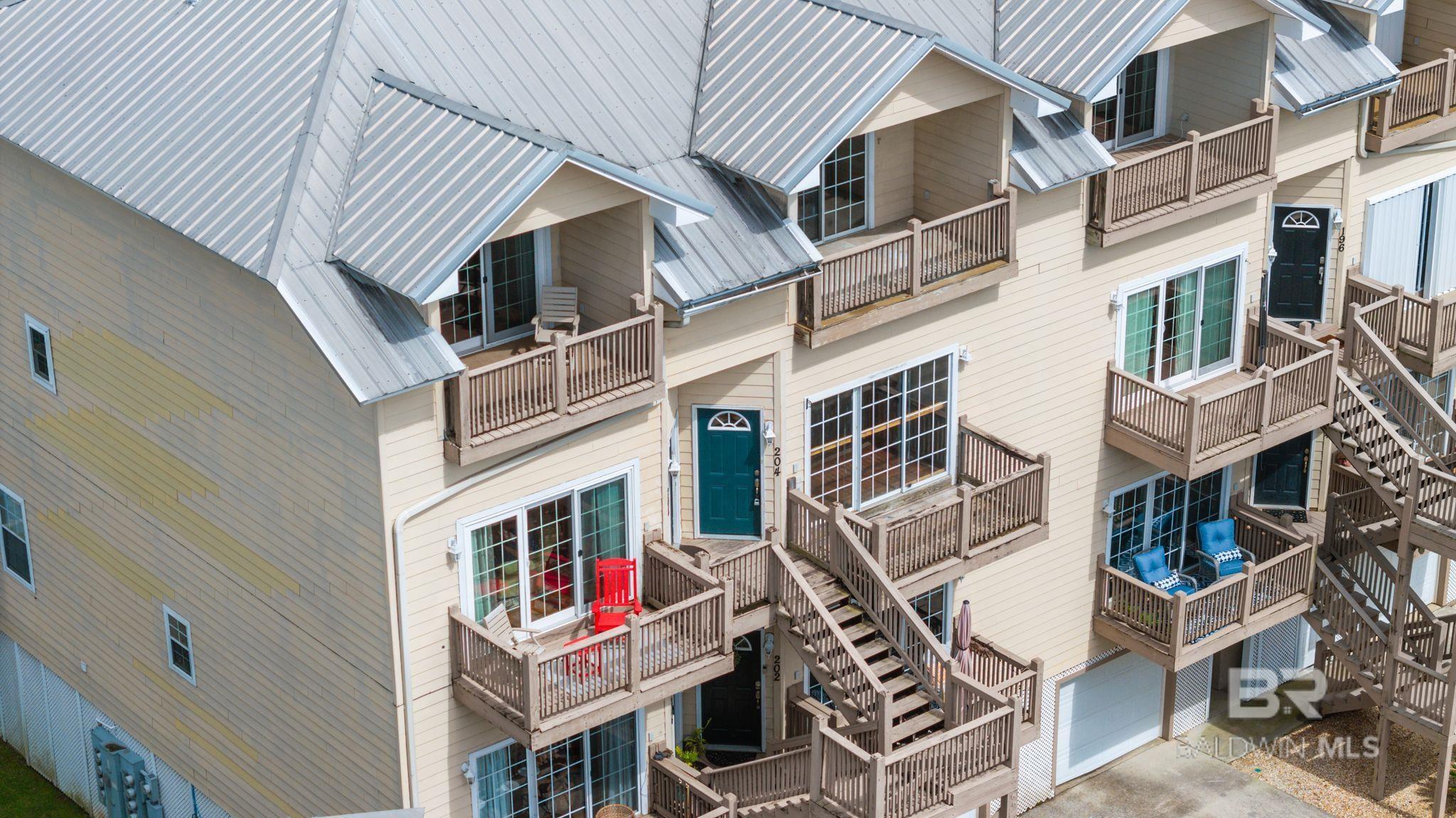 Amazing views of Mobile Bay from this super spacious two bedroom at Sunset Bay Villas! Unmatched sunsets from either of the balconies this unit has to offer. Both bedrooms are oversized - one located downstairs and one upstairs with a private balcony. Unit has a shared elevator (shared with 3 other units) that opens directly into the residence. Single car garage. HVAC less than 5 years old. Condo amenities include pool, lake, pier, gazebo, grilling area.  Buyer to verify all information during due diligence.